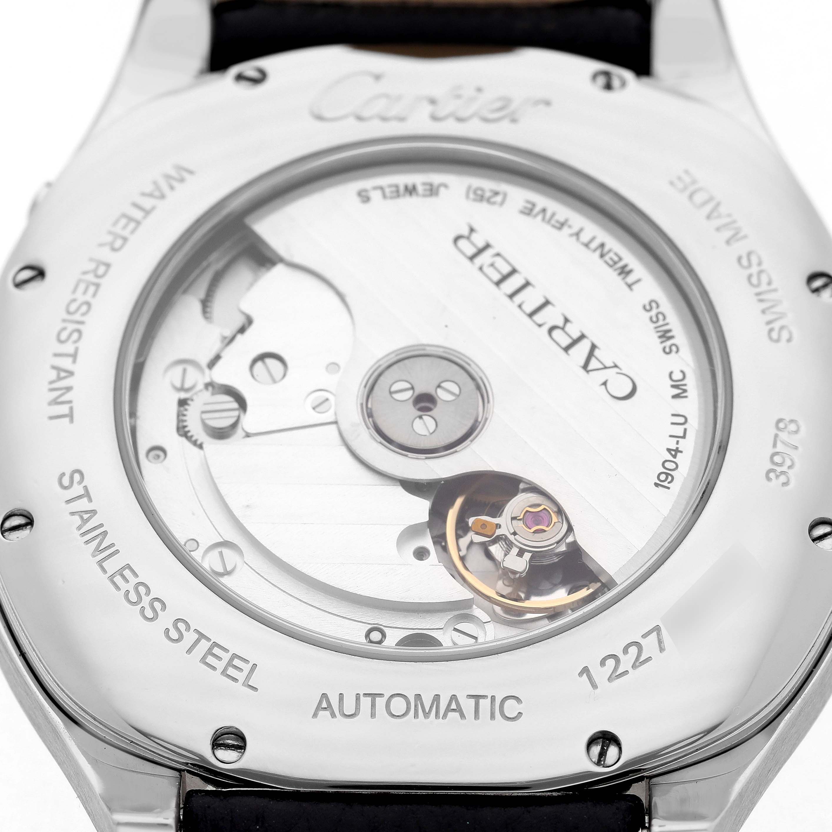 The image shows the back of a Drive de Cartier watch, highlighting its automatic movement mechanism and stainless steel case.