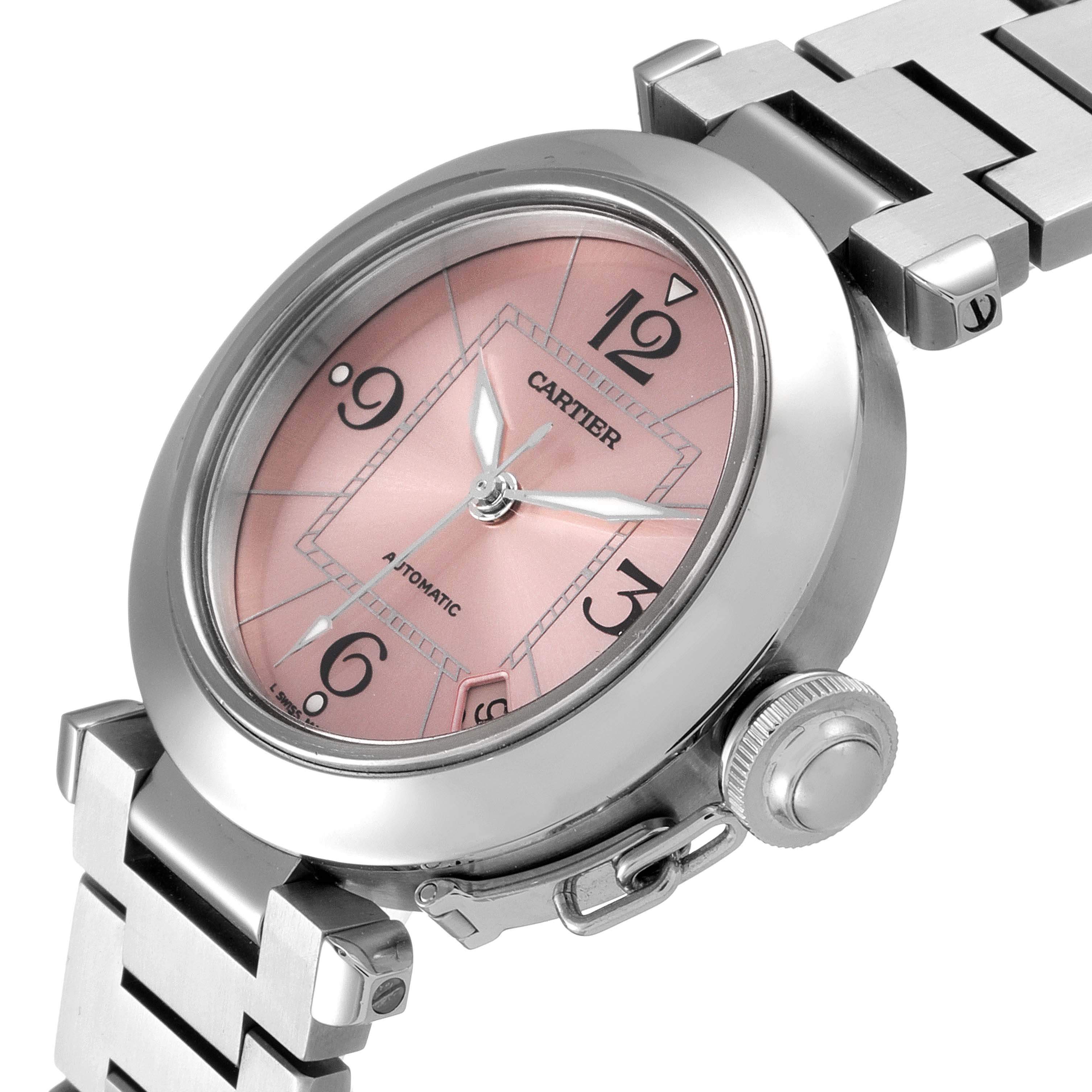 The image shows the Cartier Pasha W31075M7 Women's Stainless Steel Pink Dial W31075M7 Women's Stainless Steel Pink Dial watch from an oblique angle, highlighting the face, crown, and part of the bracelet.