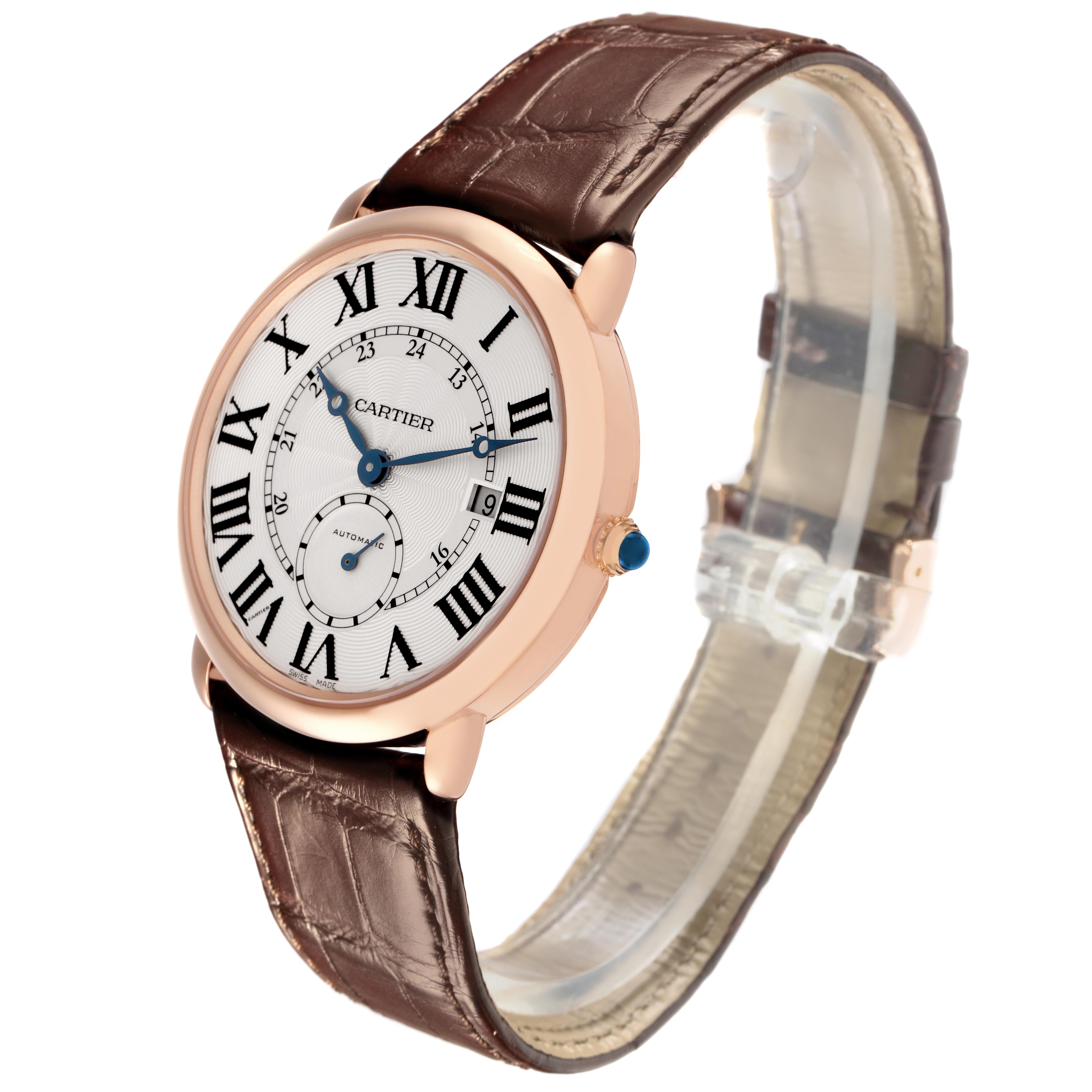 The Cartier Ronde W6801005 Men
s Rose Gold Silver Dial W6801005 Men
s Rose Gold Silver Dial watch is shown at a three-quarter angle, highlighting its Roman numeral dial, brown leather strap, and side crown.