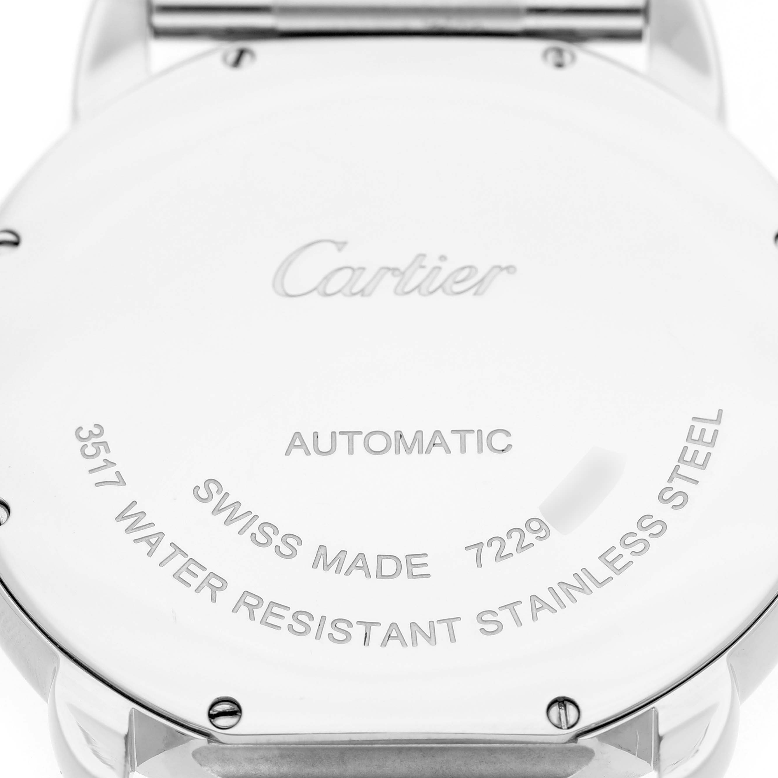 The image shows the back of a Cartier Ronde W6701011 Men's Stainless Steel Silver Dial watch, displaying engravings and fasteners.