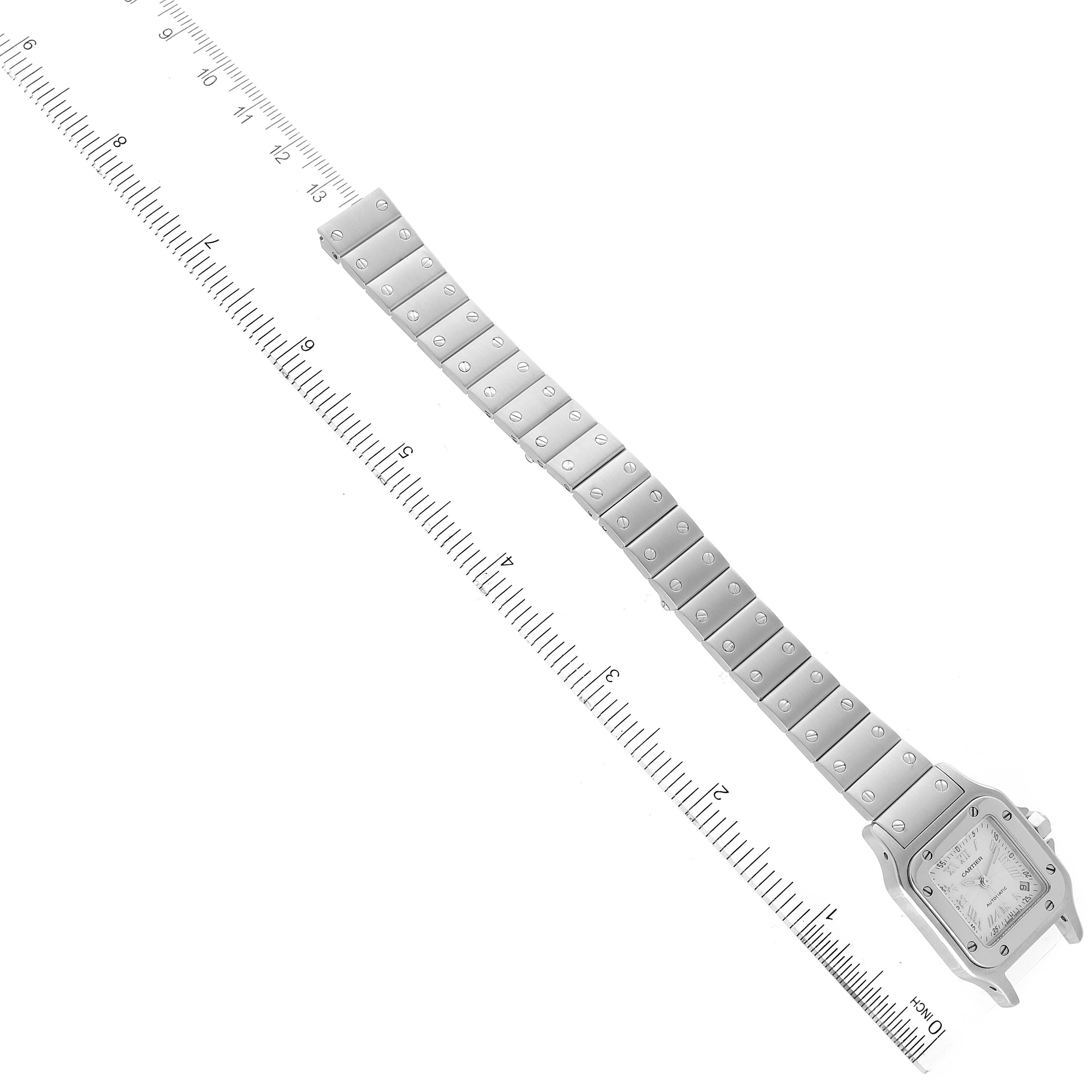 The image shows the entire Santos model by Cartier from an overhead angle, along with a ruler for scale.