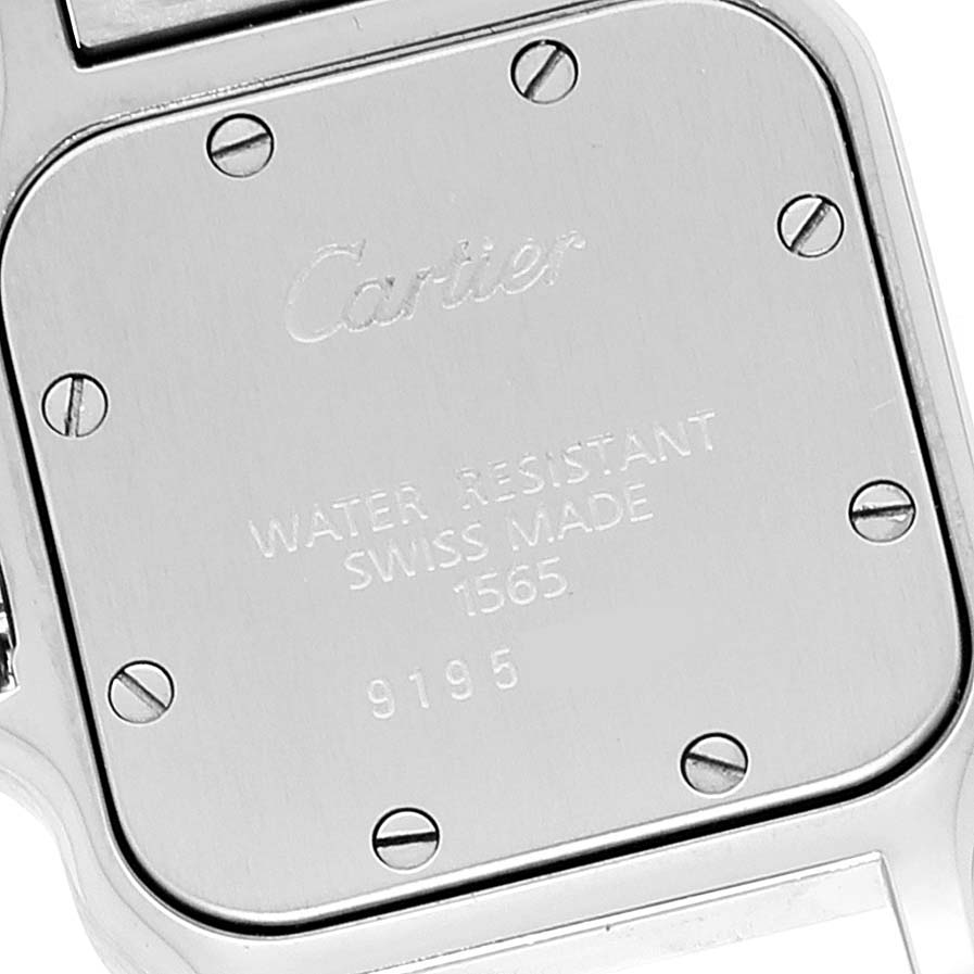 This image shows the back case of the Santos model watch by Cartier, featuring screws and engraved text.
