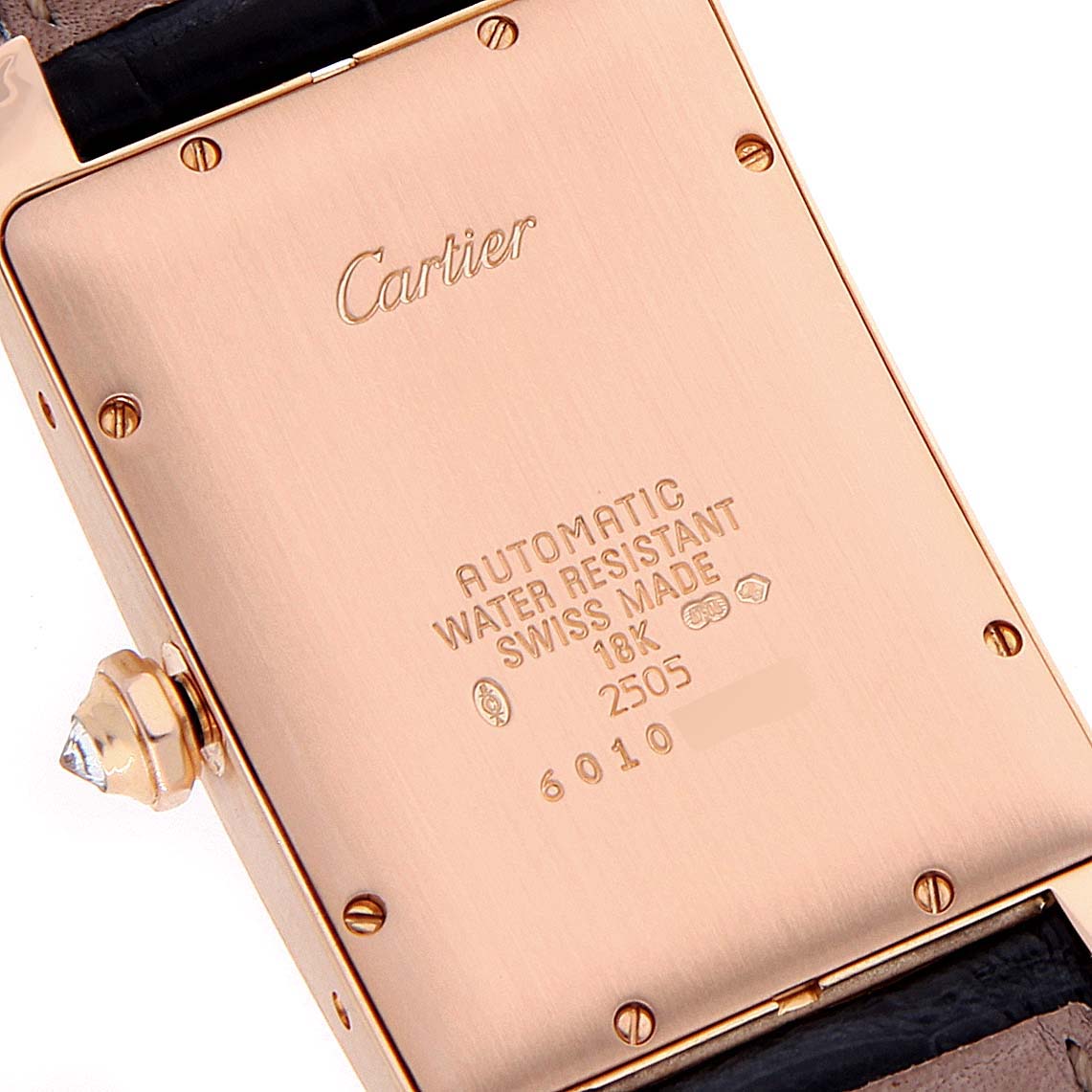 This image shows the back case of the Tank Américaine watch by Cartier, highlighting details like the brand logo, water resistance, and gold content.