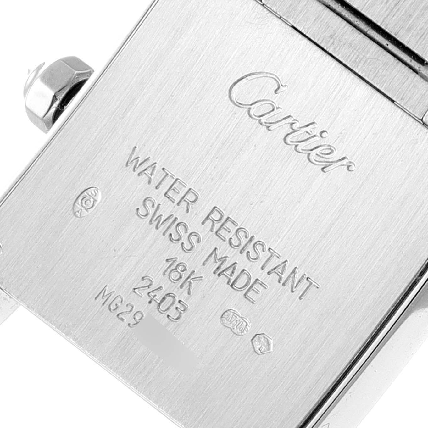 This image shows the engraved back case of a Tank Française model by Cartier, highlighting its details and specifications.