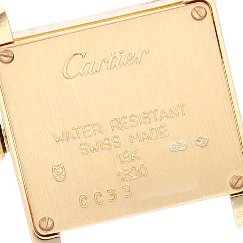 The image shows the back case of a Cartier Tank Francaise W5000256 Women's Yellow Gold Silver Dial W5000256 Women's Yellow Gold Silver Dial watch, highlighting the engravings and screws.