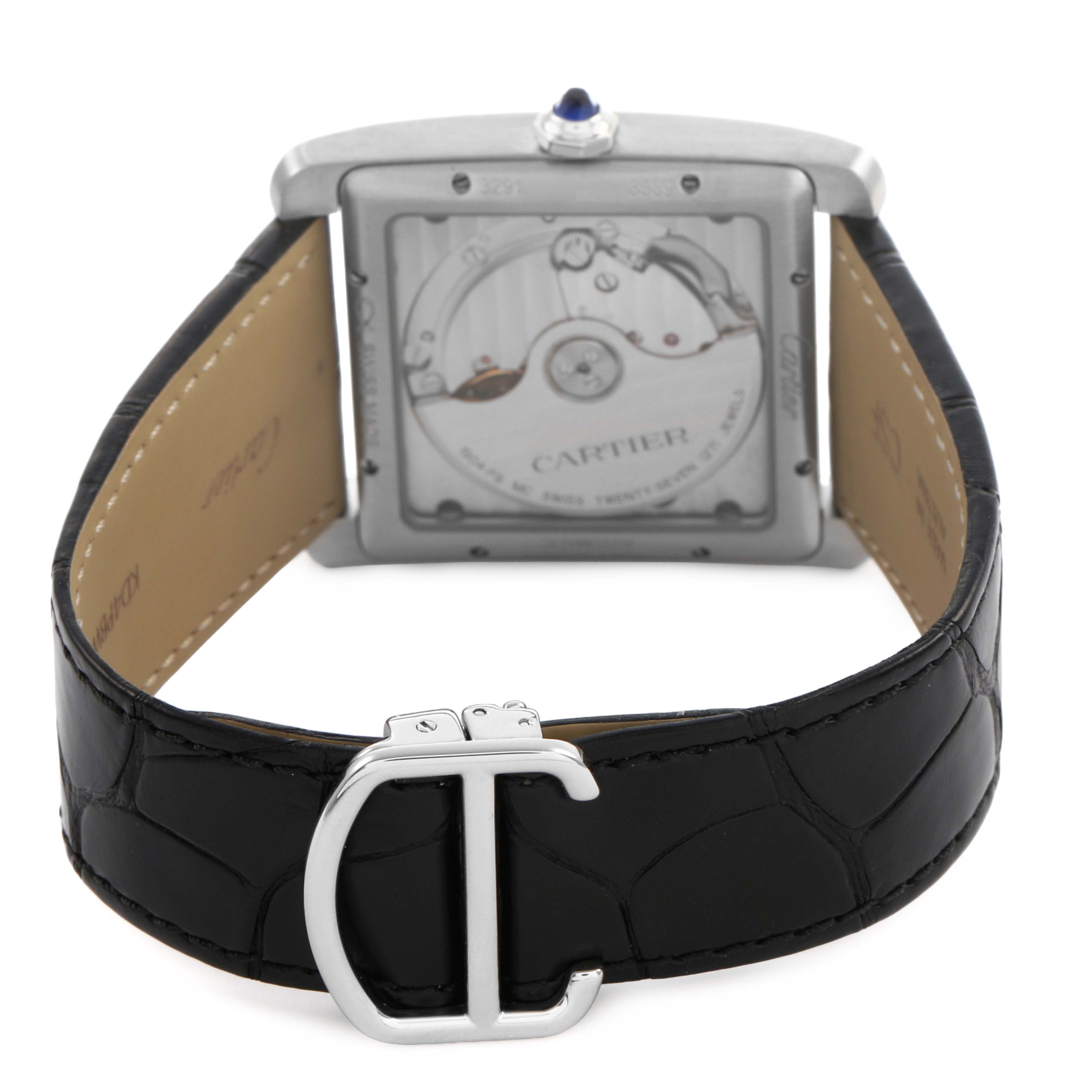 The Cartier Tank MC W5330003 Men's Stainless Steel Silver Dial watch is shown from the back, highlighting the movement and black leather strap with a "C" shaped clasp.