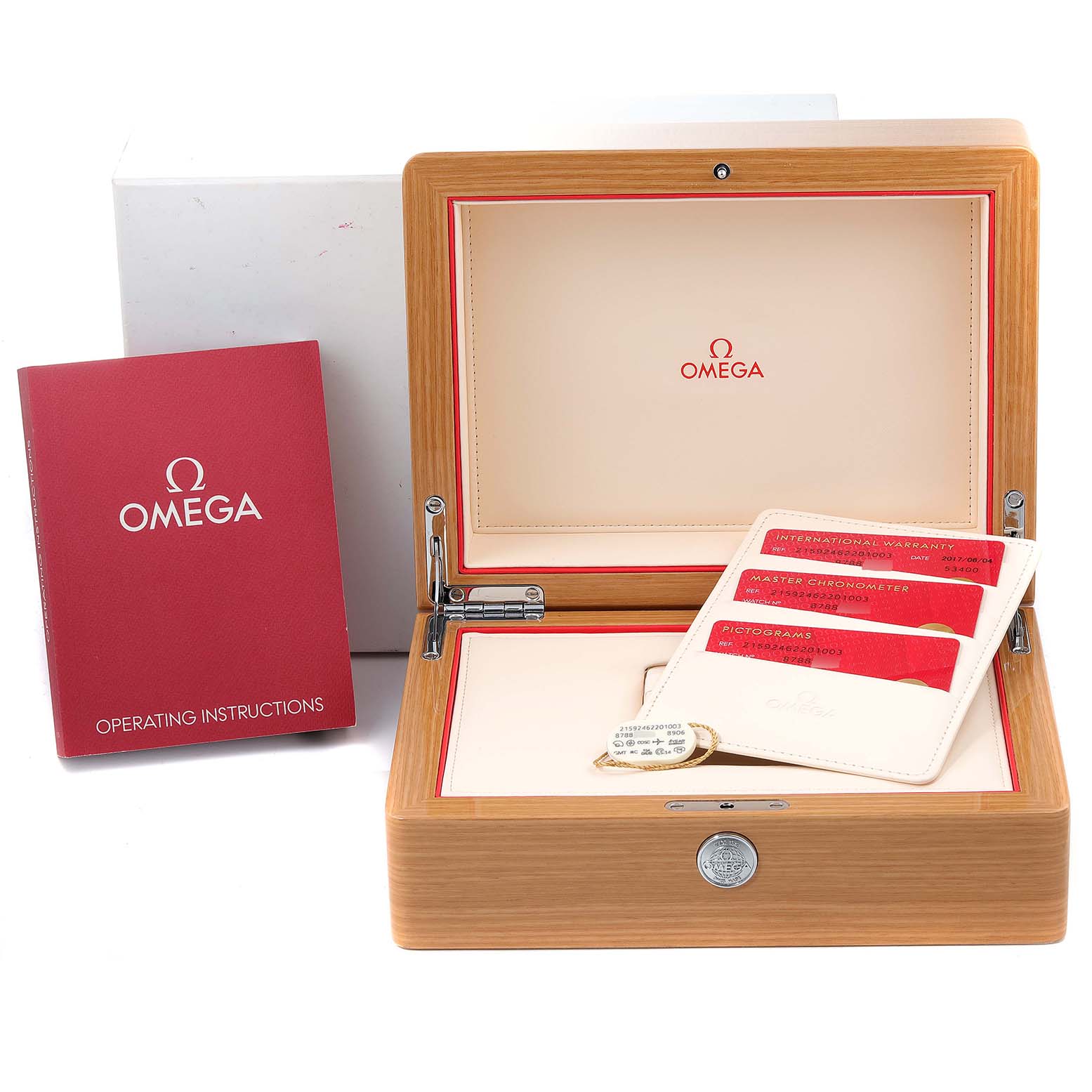 The image shows the open packaging of an Omega Planet Ocean 215.92.46.22.01.003 Men's Ceramic Black Dial 215.92.46.22.01.003 Men's Ceramic Black Dial watch, revealing the operating instructions and warranty cards.