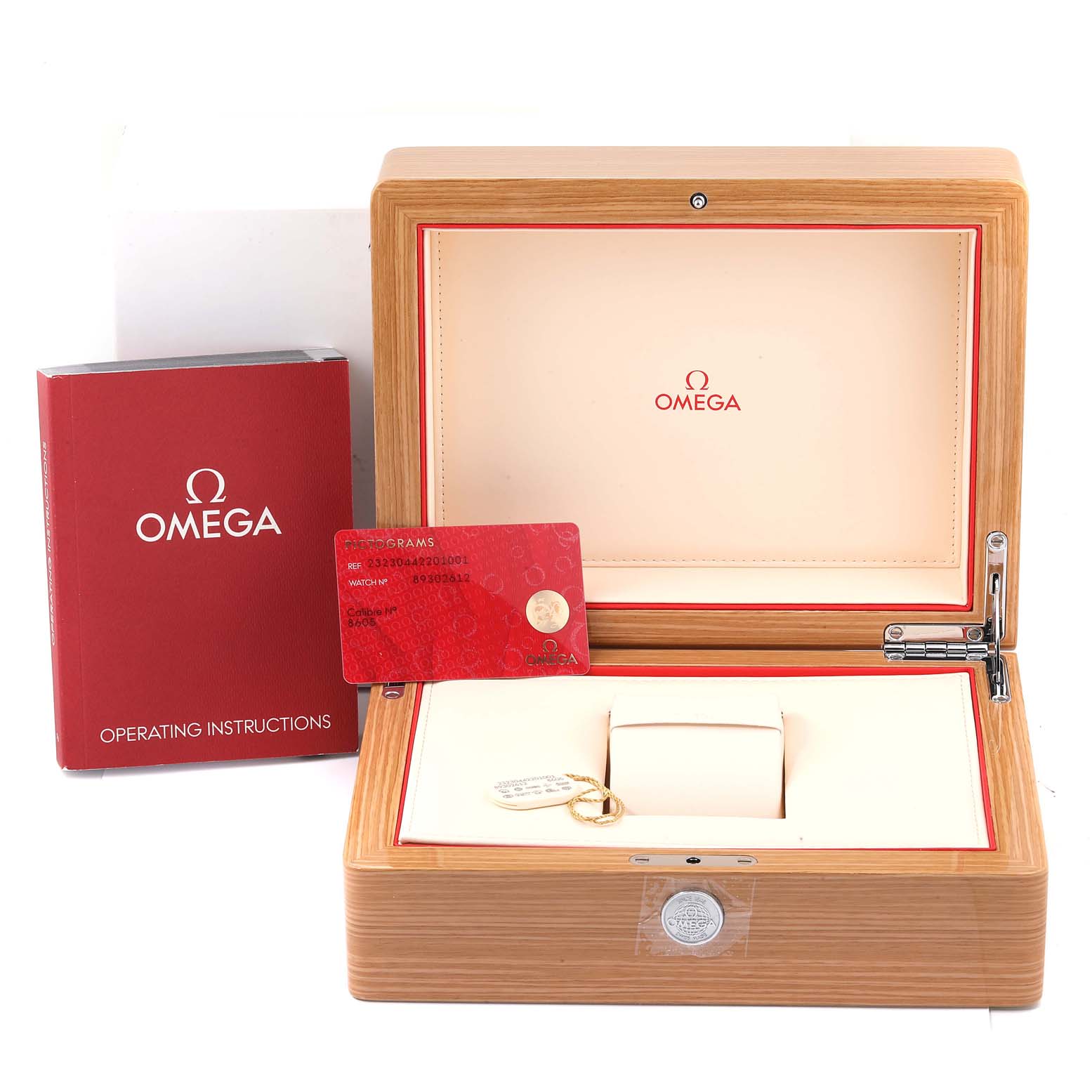 This image shows the packaging accessories for the Omega Planet Ocean 232.30.44.22.01.001 Men
s Stainless Steel Black Dial 232.30.44.22.01.001 Men
s Stainless Steel Black Dial model, including a wooden box, operating instructions, and a warranty card.