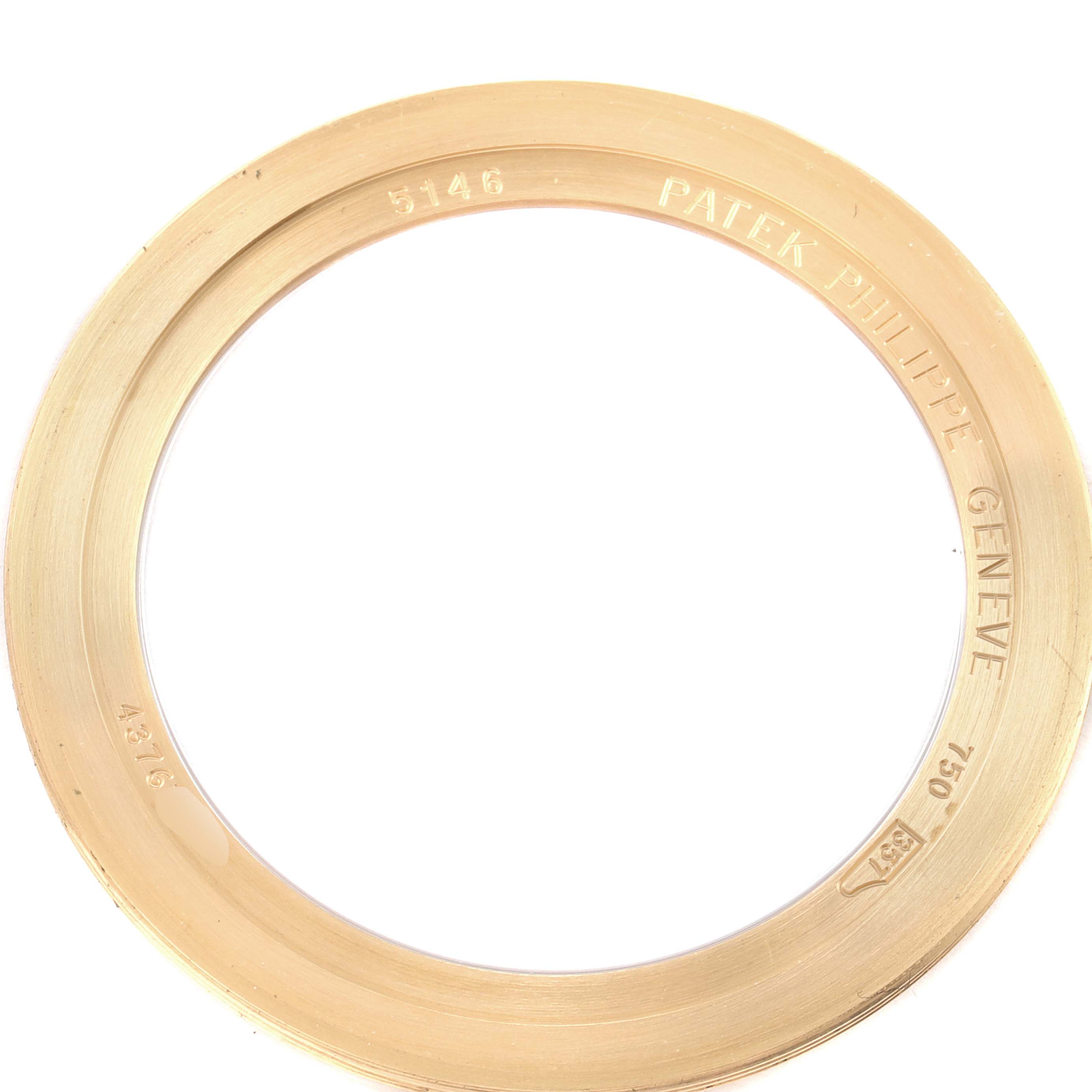 The image shows a close-up view of the yellow gold bezel for the Patek Philippe 5146J - 01D Men
s Yellow Gold Grey Dial 5146J - 01D Men
s Yellow Gold Grey Dial Complicated Annual Calendar Men
s Watch model 5146.