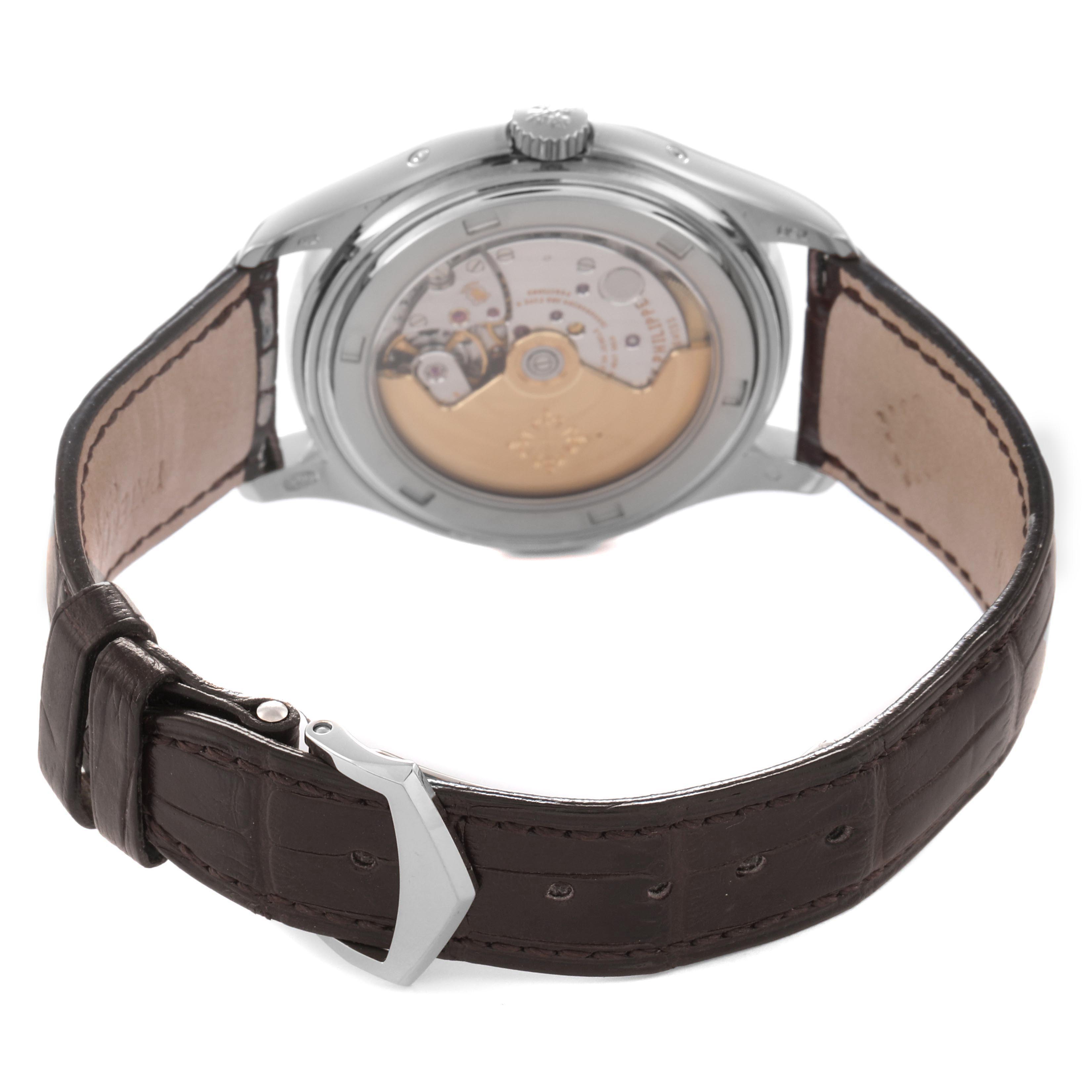 The image shows the back view of a Patek Philippe Complications 5146G Men's White Gold White Dial 5146G Men's White Gold White Dial watch, highlighting its movement and leather strap.