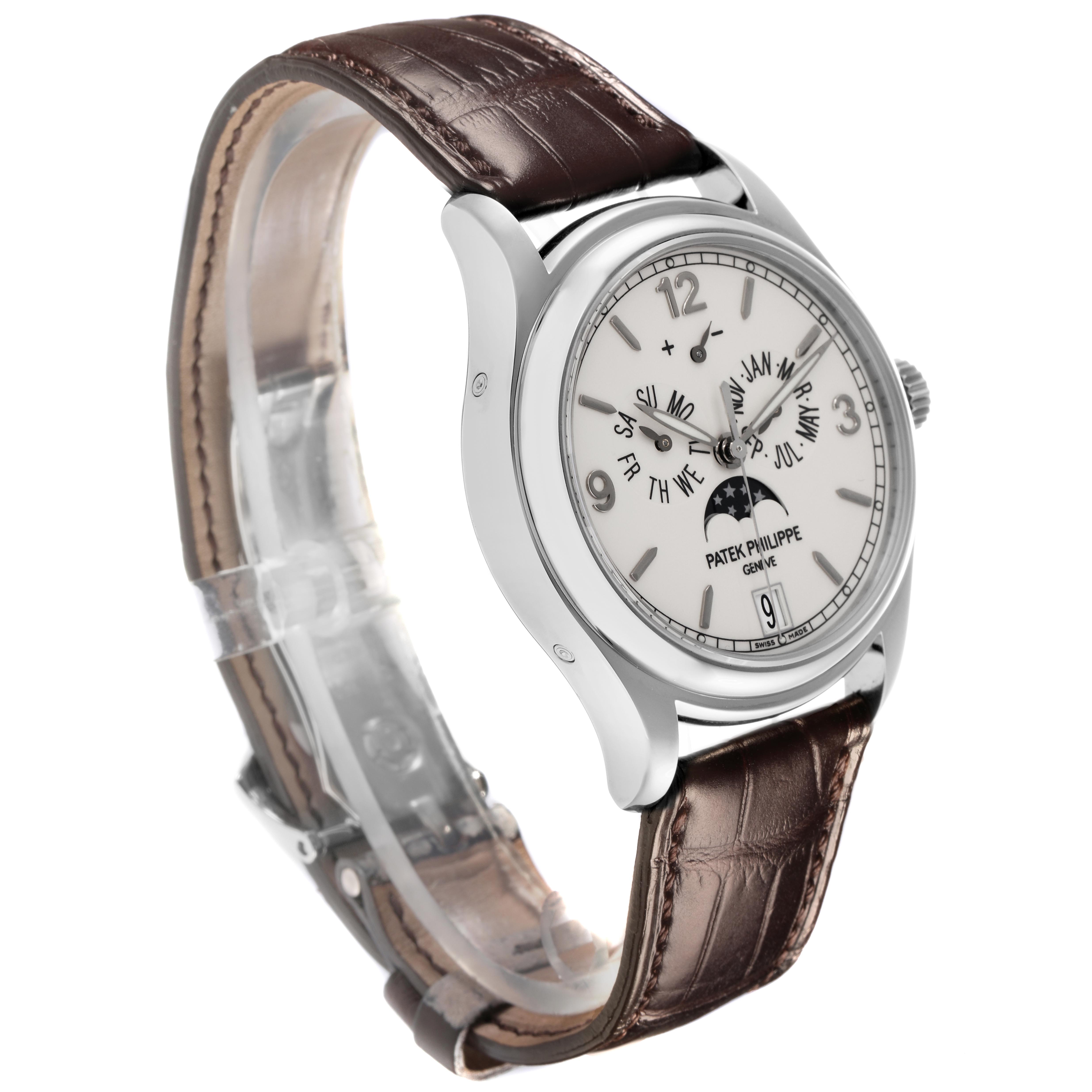 The Patek Philippe Complications 5146G Men's White Gold White Dial 5146G Men's White Gold White Dial watch is shown at a three-quarter angle, highlighting the face and the brown leather strap.