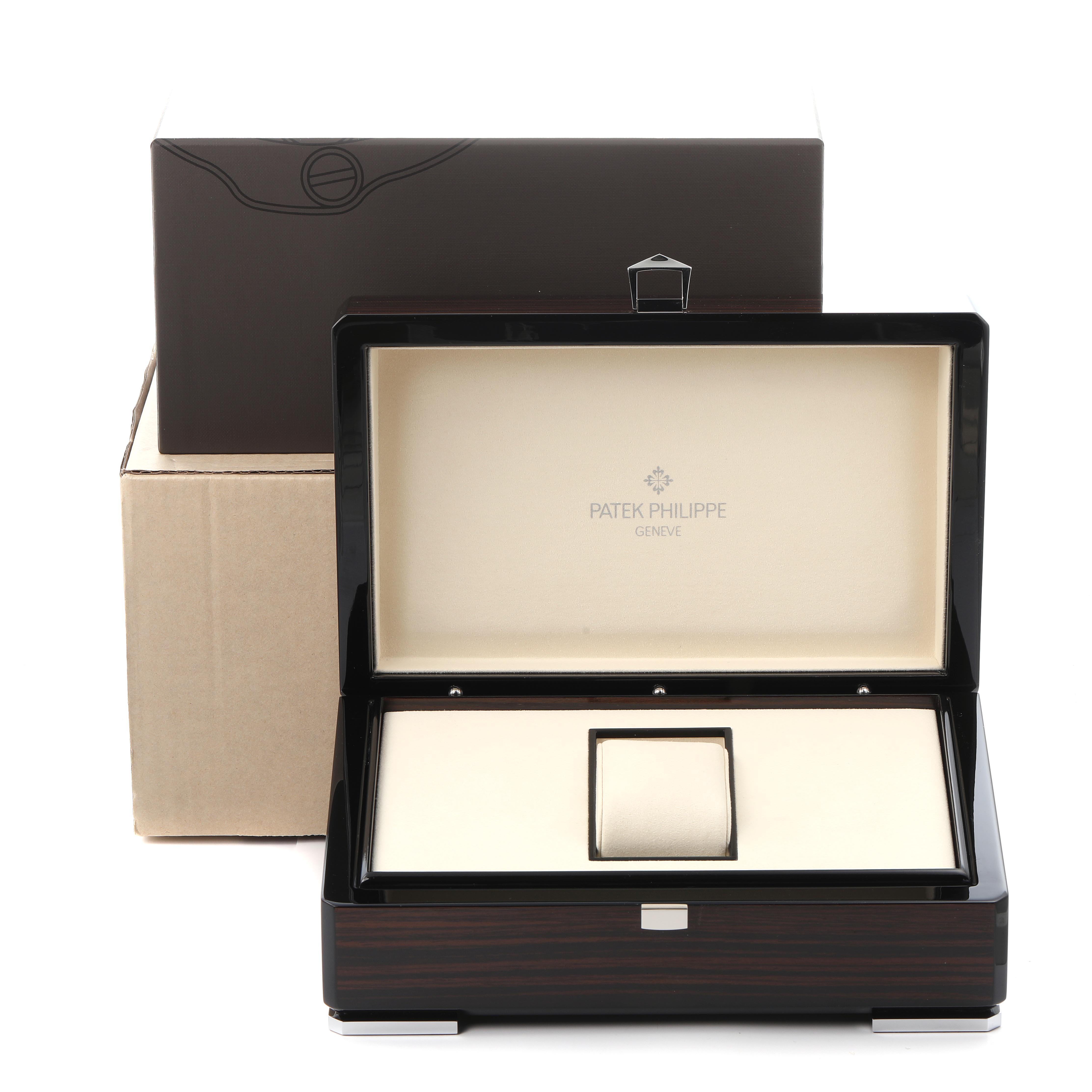 The image shows an open Patek Philippe Complications 5146G Men's White Gold White Dial 5146G Men's White Gold White Dial watch box with a beige interior and its exterior packaging.