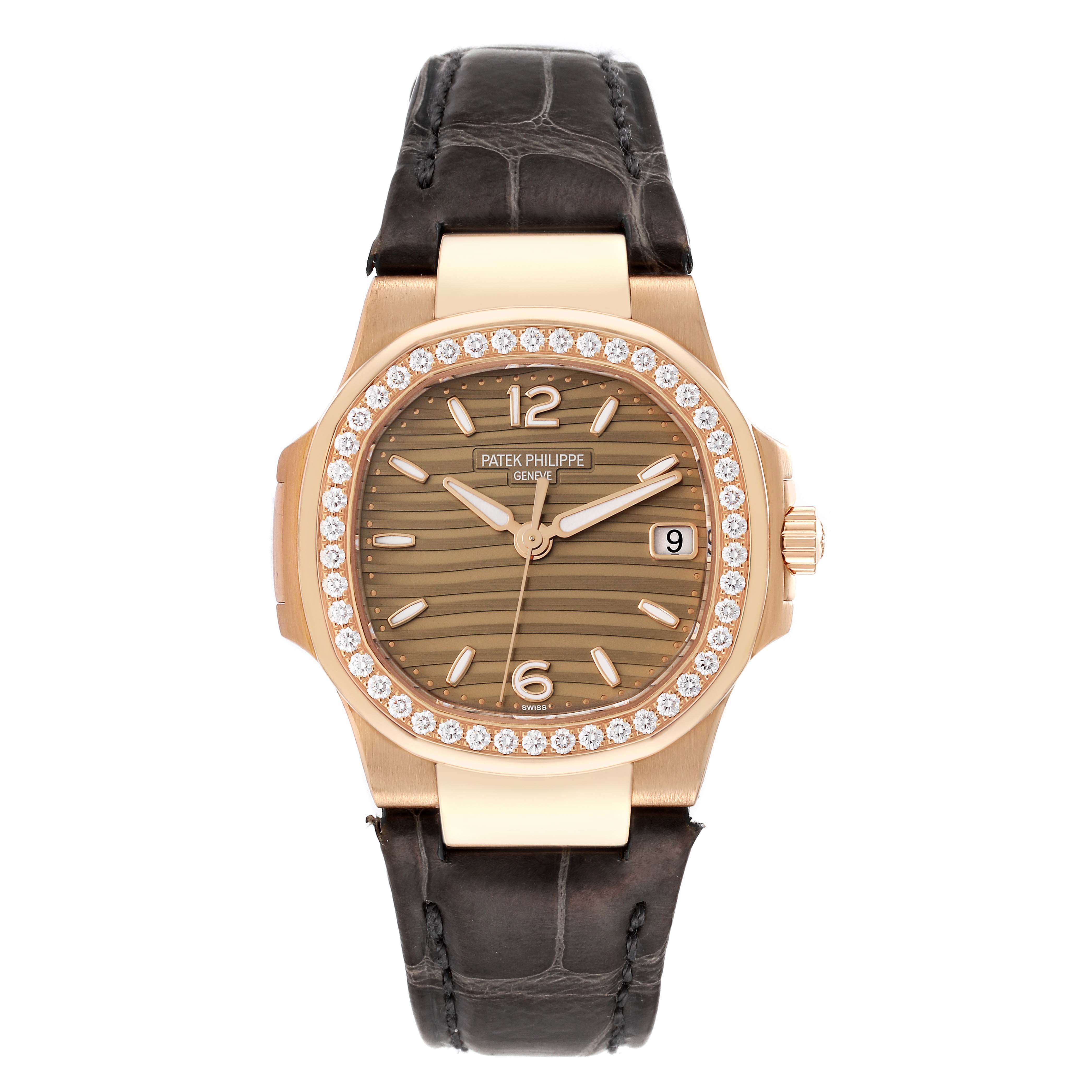 The image shows a front view of a Patek Philippe Nautilus 7010R-012 Women's Rose Gold Champagne Dial 7010R-012 Women's Rose Gold Champagne Dial watch with a leather strap and diamond-encrusted bezel.