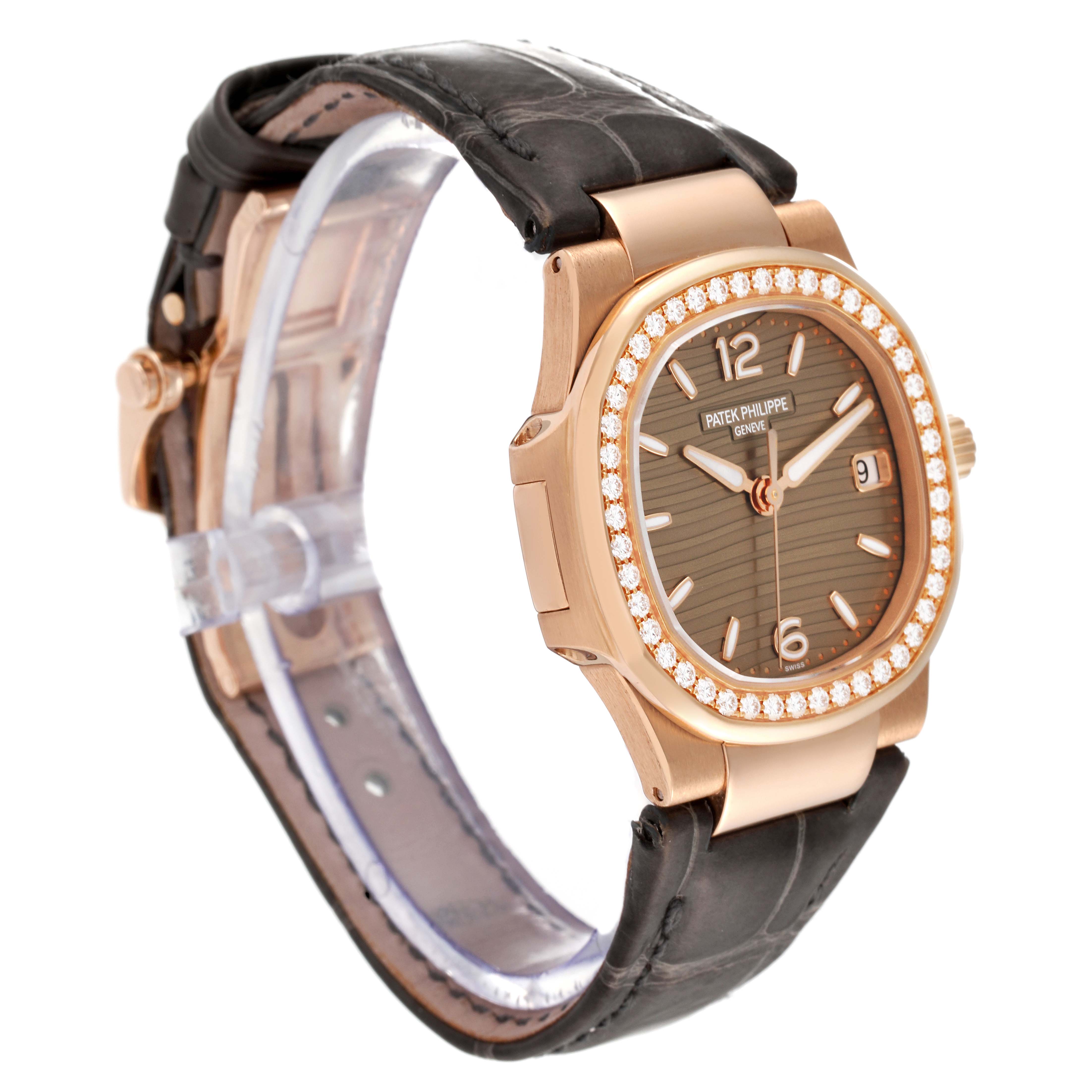 The image shows a side-angle view of a Patek Philippe Nautilus 7010R-012 Women's Rose Gold Champagne Dial 7010R-012 Women's Rose Gold Champagne Dial watch, highlighting its diamond bezel, dial, and leather strap.