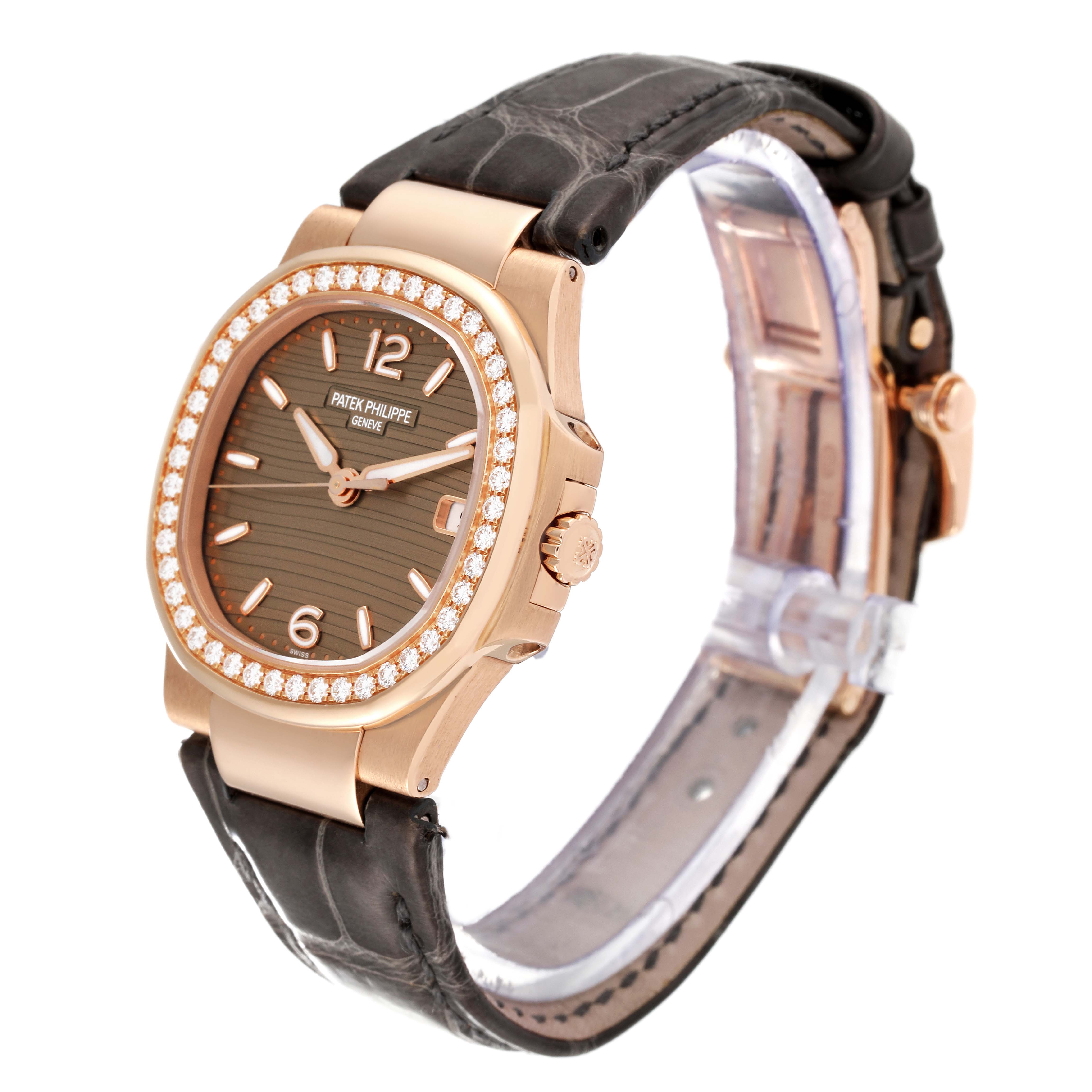 The image shows a Patek Philippe Nautilus 7010R-012 Women's Rose Gold Champagne Dial 7010R-012 Women's Rose Gold Champagne Dial watch angled to display the dial, bezel, and part of the strap.