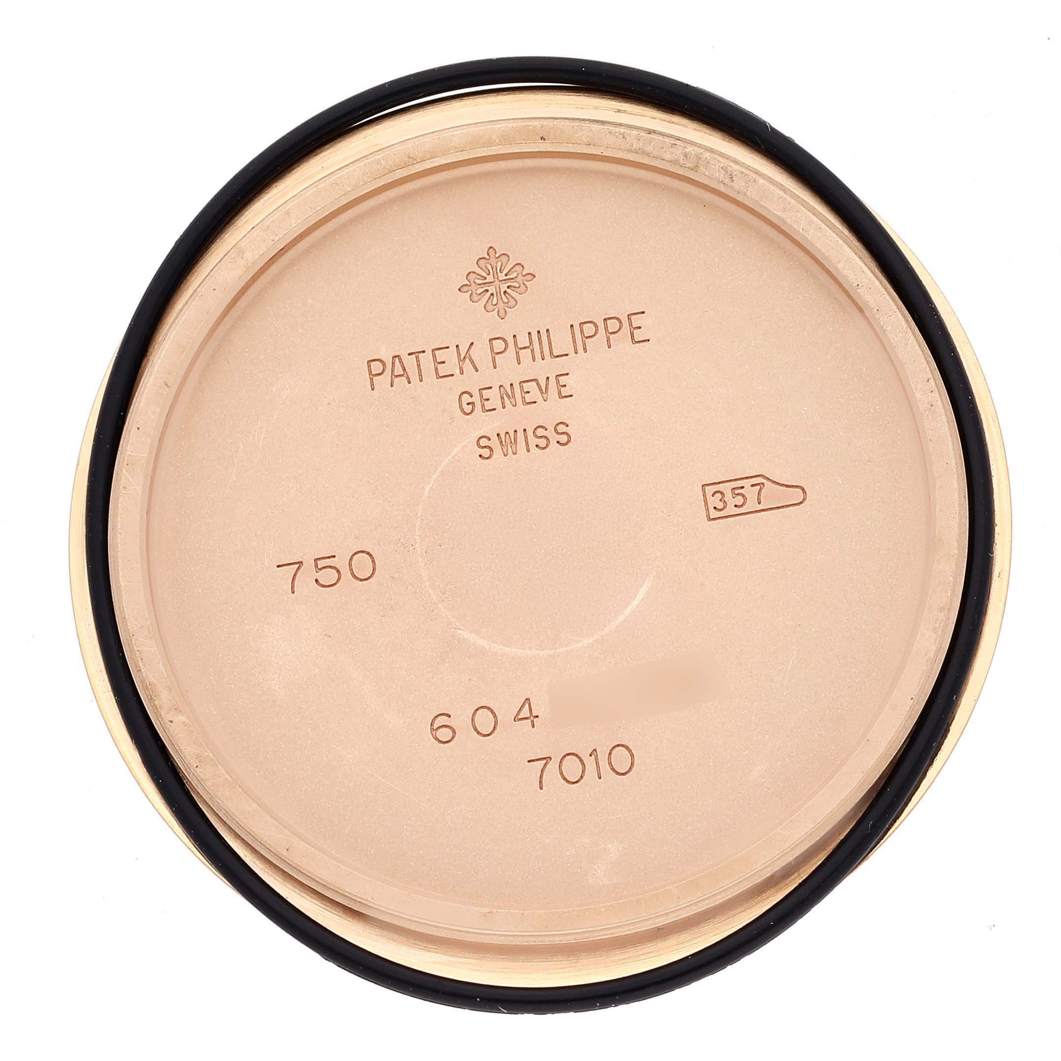 The image shows the case back of a Patek Philippe Nautilus 7010R-012 Women's Rose Gold Champagne Dial watch, displaying inner engravings and markings.