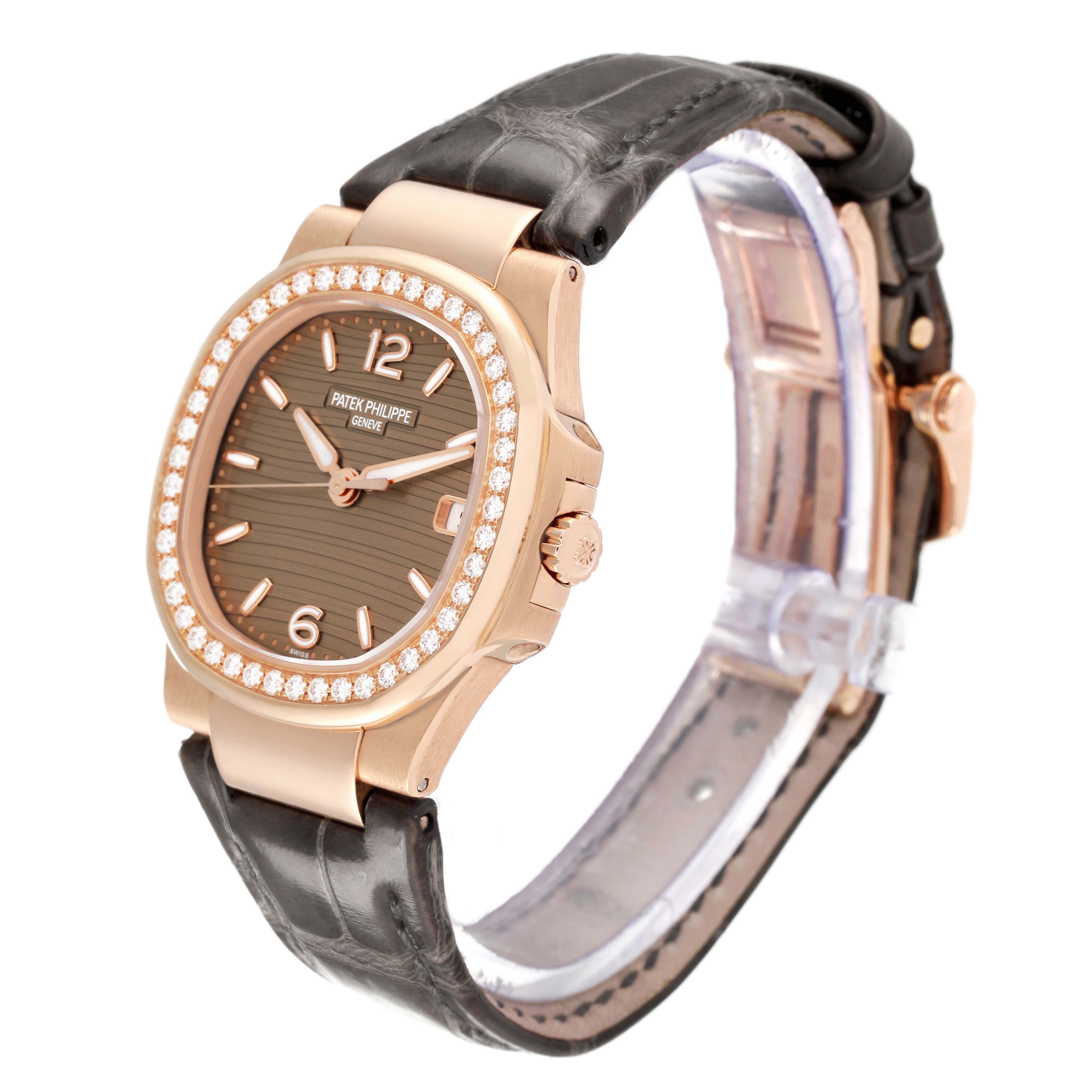 The Patek Philippe Nautilus 7010R-012 Women's Rose Gold Champagne Dial is shown at a three-quarter angle, highlighting its diamond bezel and textured dial.