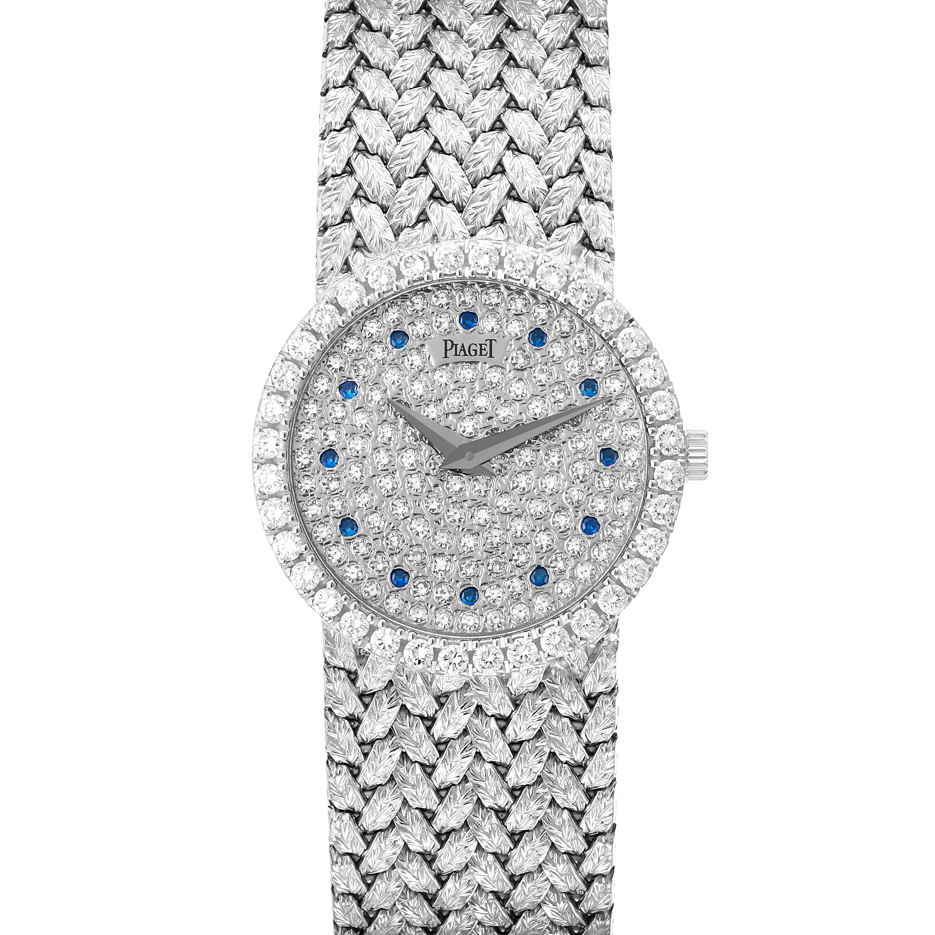 The Piaget 9706D2 Women
s White Gold Silver Dial 9706D2 Women
s White Gold Silver Dial Tradition 9706D2 watch is shown from a top view, highlighting its diamond and sapphire-encrusted face and woven strap.