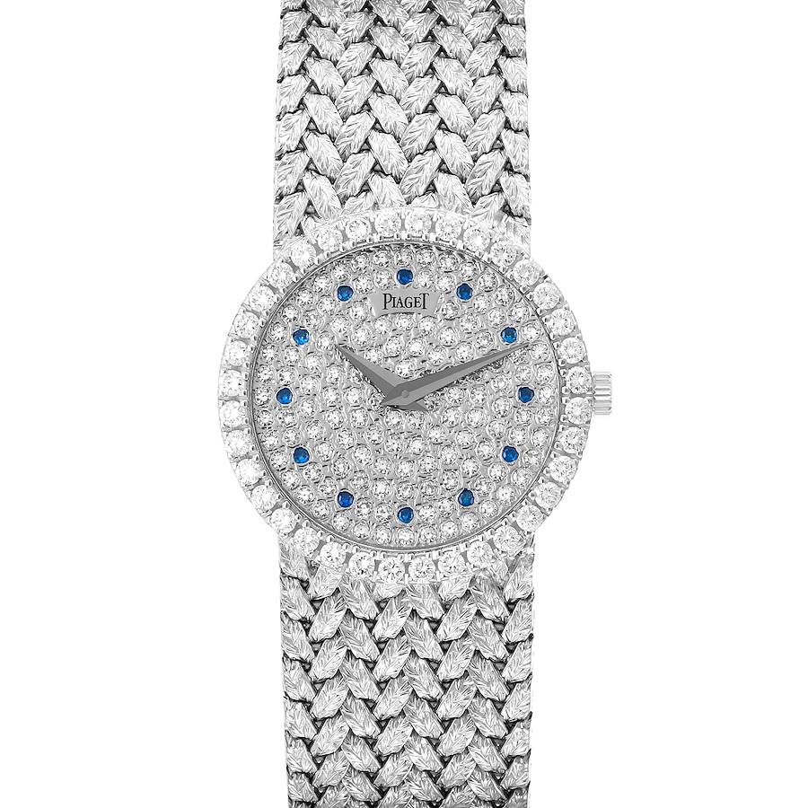 The Piaget Tradition 9706D2 watch is shown from a top view, highlighting its diamond and sapphire-encrusted face and woven strap.