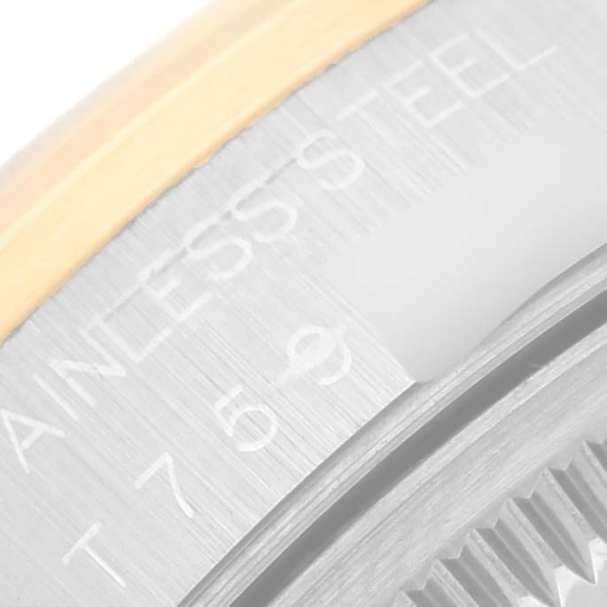 This image shows a close-up angle of the side engraving on a Rolex Date 15203 Men
s Steel and Gold (two tone) Blue Dial 15203 Men
s Steel and Gold (two tone) Blue Dial model watch, highlighting details like the "STAINLESS STEEL" marking.