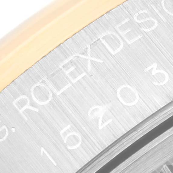 This close-up image shows part of the case back engraving on a Rolex Date 15203 Men
s Steel and Gold (two tone) Blue Dial 15203 Men
s Steel and Gold (two tone) Blue Dial model watch.