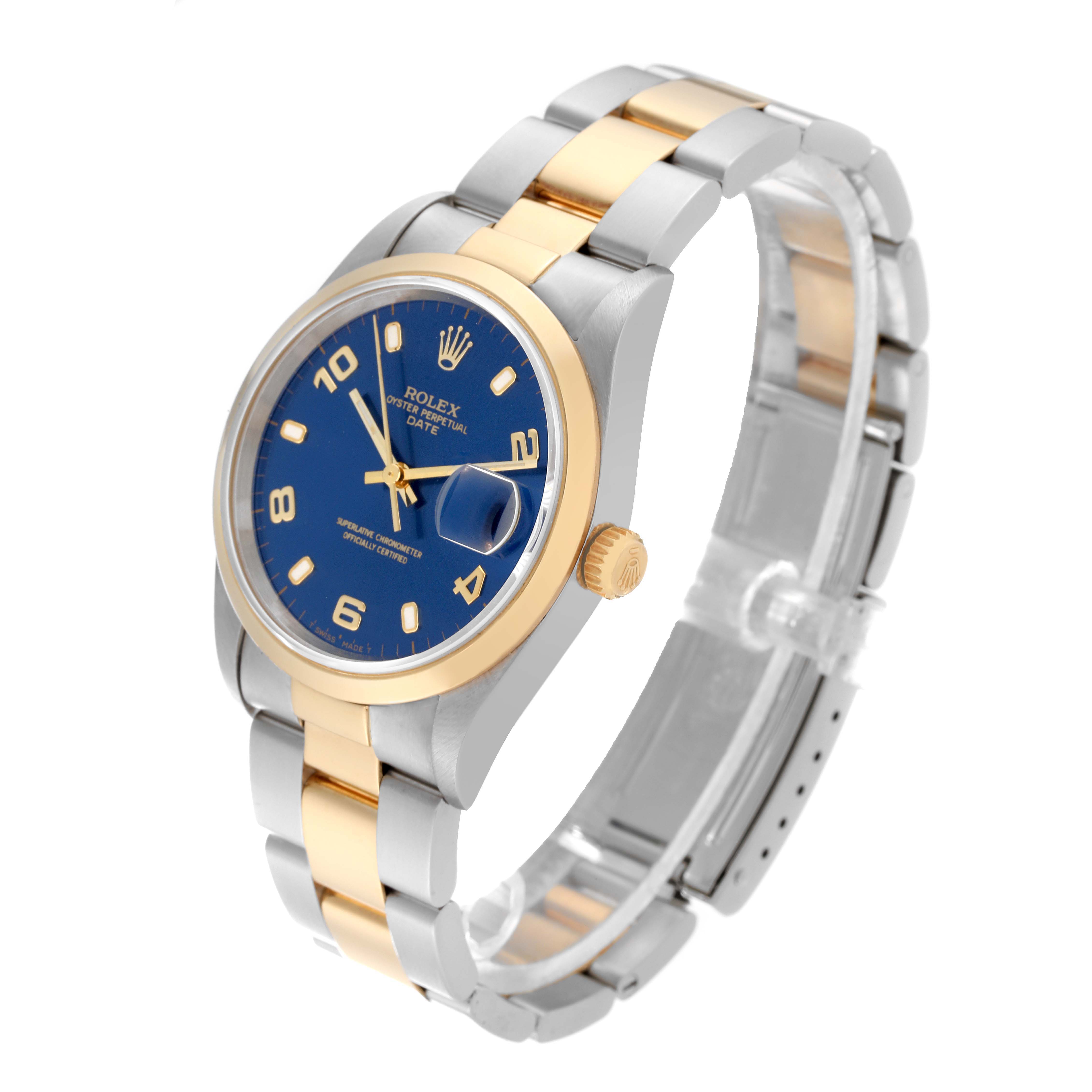 The image shows a Rolex Date 15203 Men
s Steel and Gold (two tone) Blue Dial 15203 Men
s Steel and Gold (two tone) Blue Dial model watch at a three-quarter angle, highlighting the blue dial, gold bezel, crown, and two-tone bracelet.