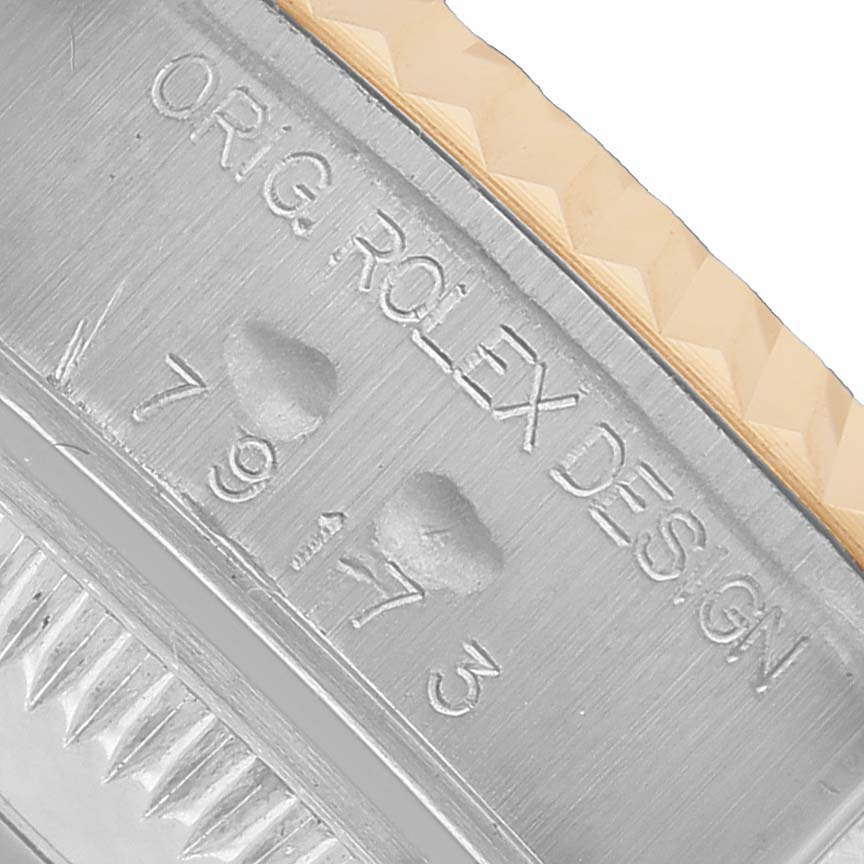 This close-up shows the engraved side of the Rolex Datejust 79173 Women's Steel and Gold (two tone) White Dial case, highlighting the design and model number.