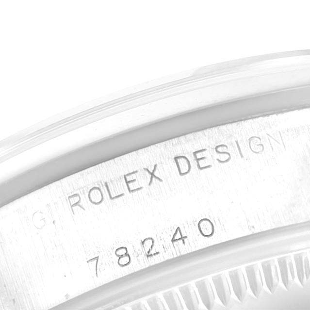 The image shows a close-up of the engraved serial number and "ROLEX DESIGN" on the case of a Mid-Size Rolex watch.