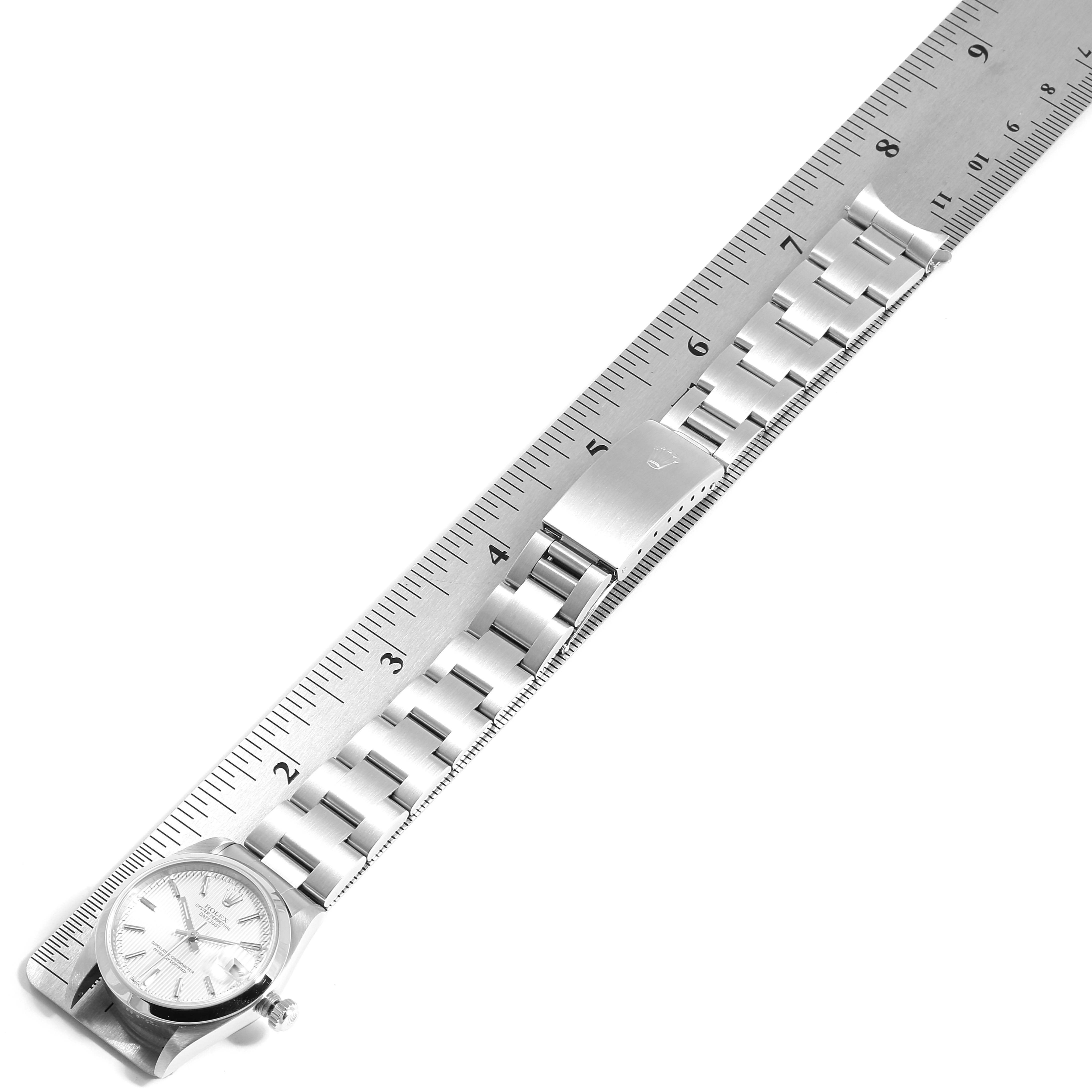 The image shows a top view of a Rolex Mid-Size 78240 Women
s Stainless Steel Silver Dial 78240 Women
s Stainless Steel Silver Dial model watch next to a ruler, highlighting its bracelet length.