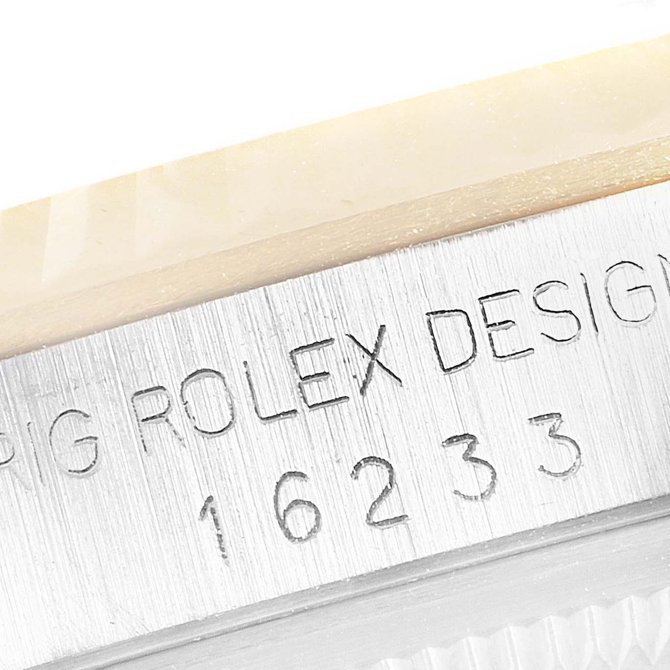 The image shows an engraved part of the case back for a Rolex Datejust 16233 Men's Steel and Gold (two tone) Blue Dial 16233 Men's Steel and Gold (two tone) Blue Dial model, highlighting the model number 16233.