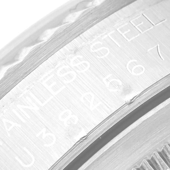 This close-up image of the Rolex Datejust 16234 Men's Stainless Steel Silver Dial 16234 Men's Stainless Steel Silver Dial watch shows a portion of the stainless steel case with engravings.