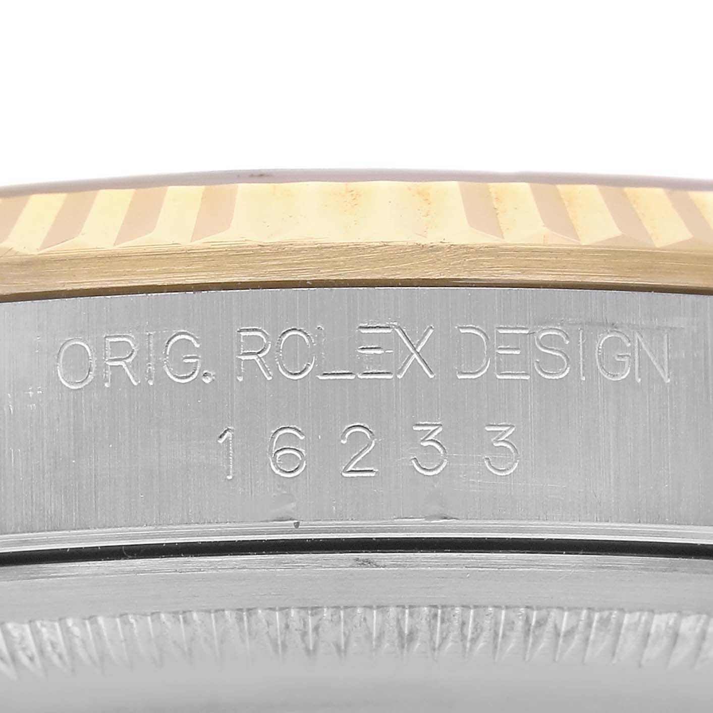 The image shows a close-up of the Rolex Datejust 81443 Men's Steel and Gold (two tone) Champagne Dial's side, highlighting the engraved model number and part of the bezel.