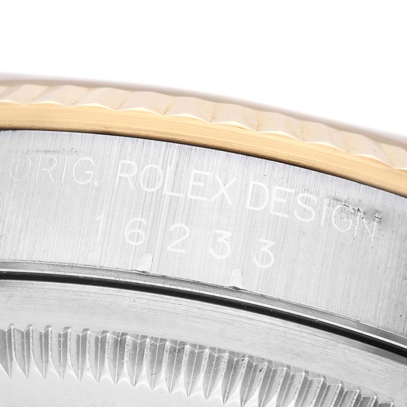 The image shows a close-up view of the side case and fluted bezel of a Rolex Datejust 16233 Men's Steel and Gold (two tone) Champagne Dial watch, highlighting the model number.