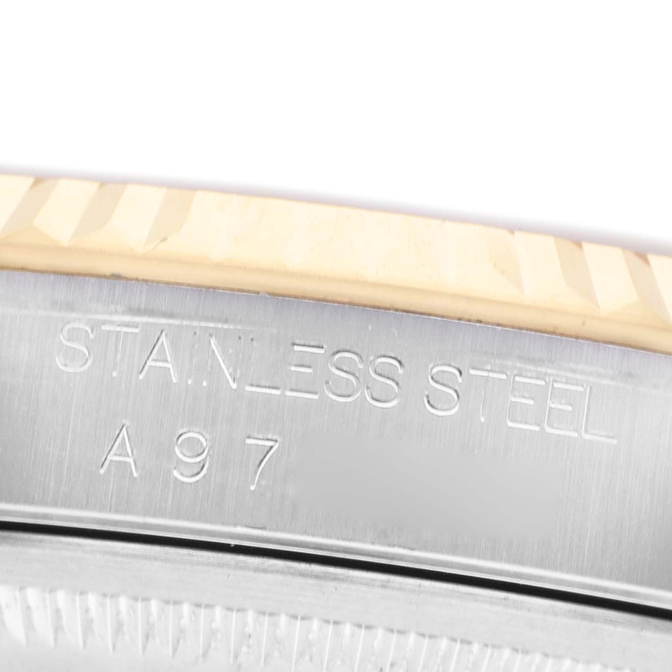 The image shows a close-up of the Rolex Datejust 16233 Men's Stainless Steel Champagne Dial watch's case edge, displaying the "STAINLESS STEEL" engraving.