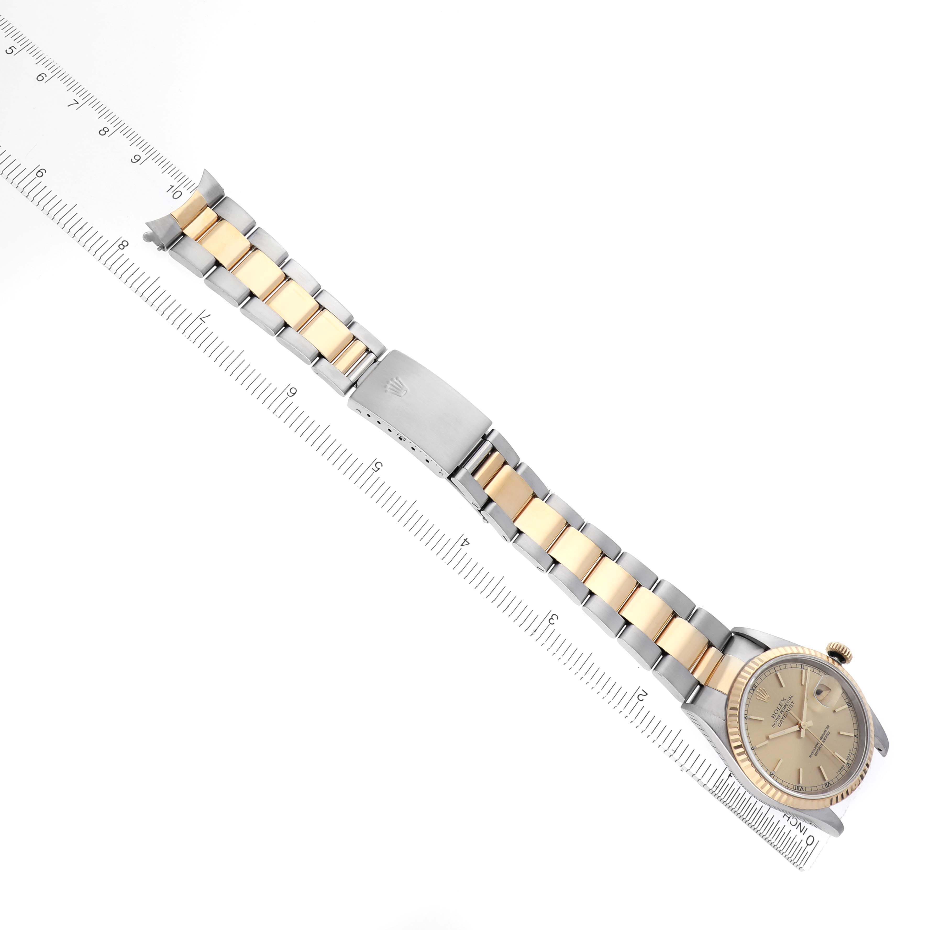 The Rolex Datejust 16233 Men's Steel and Gold (two tone) Champagne Dial 16233 Men's Steel and Gold (two tone) Champagne Dial watch is displayed from an overhead angle, showing the full bracelet, case, and partially closed clasp.