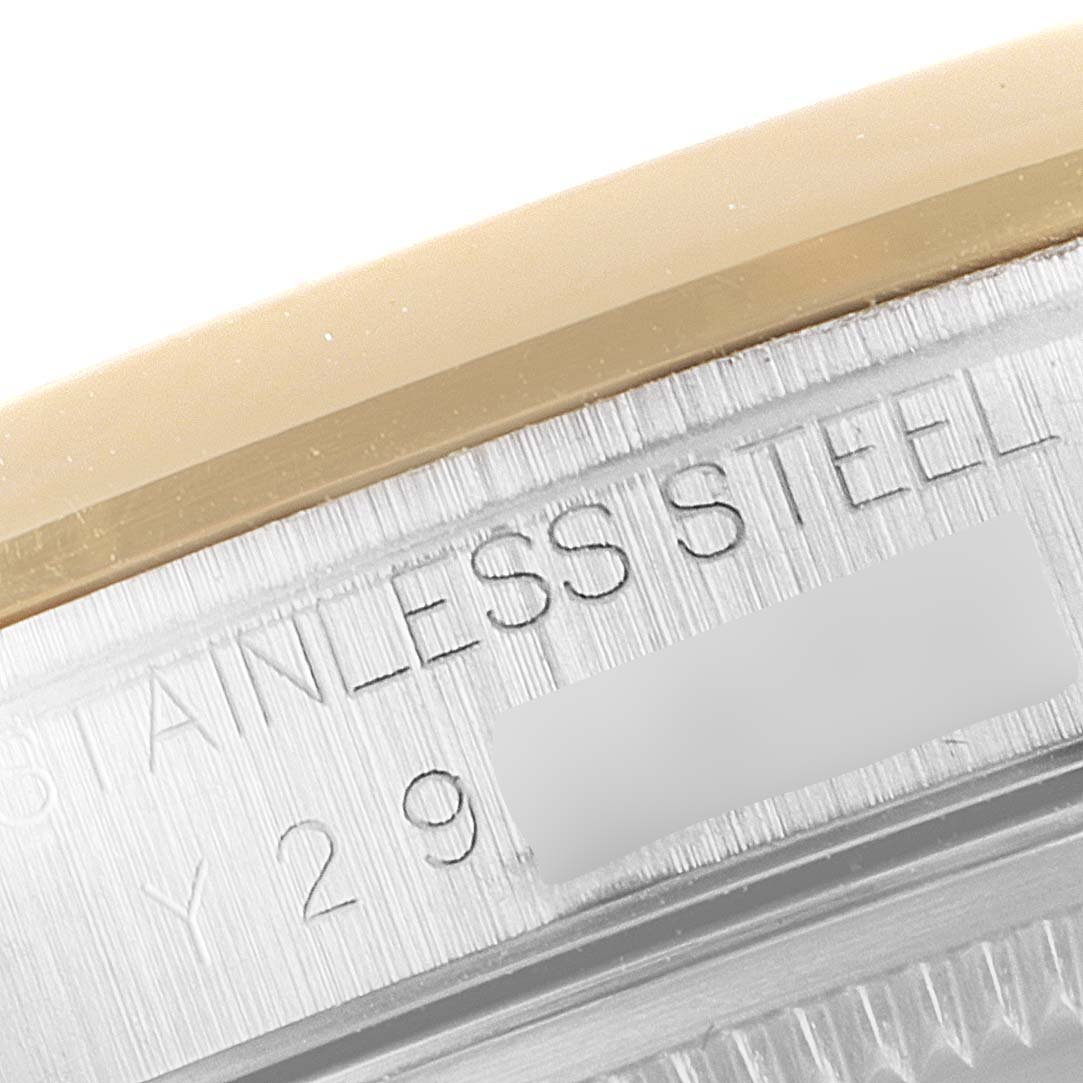 This close-up image shows the stainless steel casing and serial engraving of a Rolex Datejust 16203 Men's Steel and Gold (two tone) White Dial 16203 Men's Steel and Gold (two tone) White Dial watch.