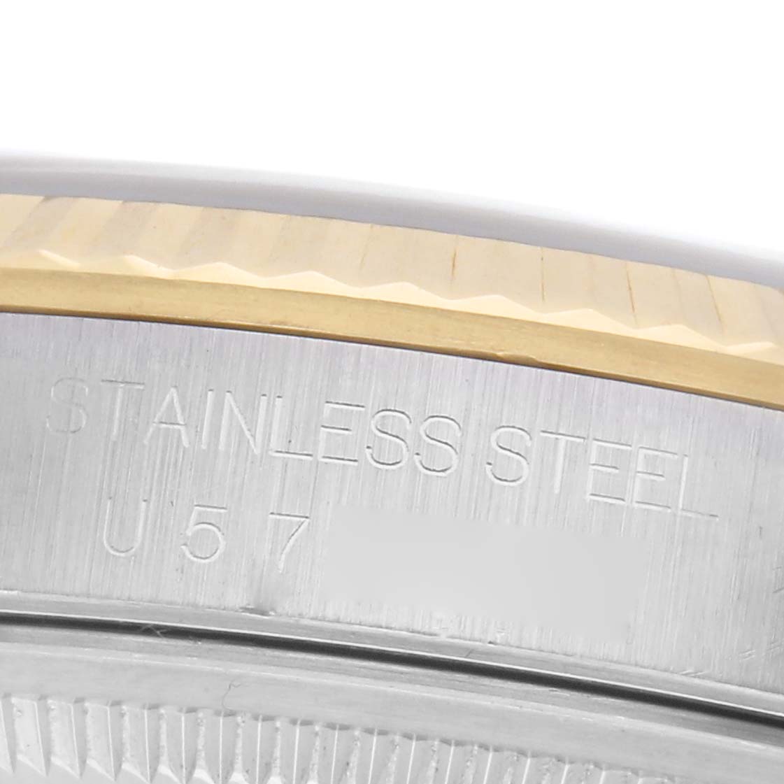 The image shows a close-up of the side of a Rolex Datejust 16233 Men
s Steel and Gold (two tone) White Dial 16233 Men
s Steel and Gold (two tone) White Dial watch, focusing on the stainless steel and gold fluted bezel.