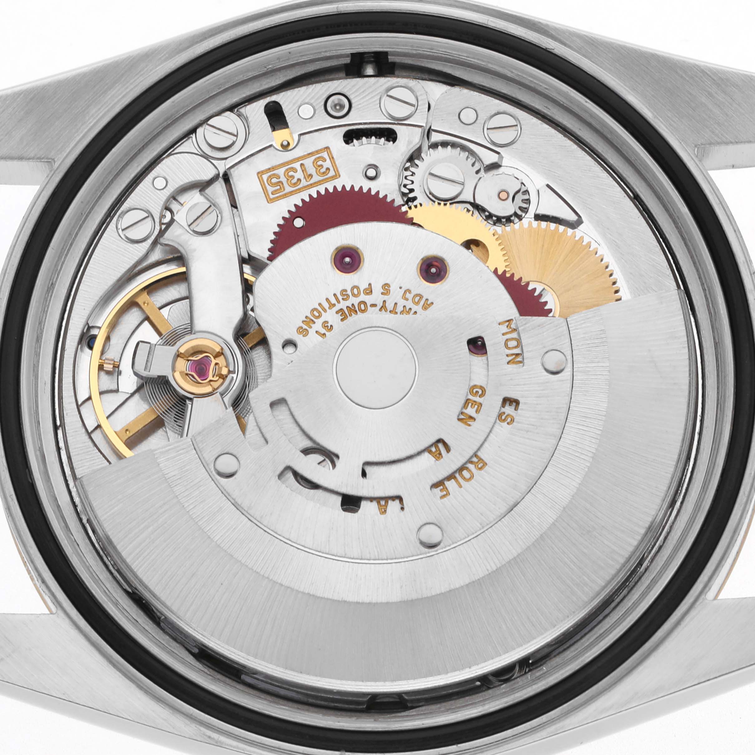 The image shows the movement of a Rolex Datejust 16233 Men
s Steel and Gold (two tone) White Dial 16233 Men
s Steel and Gold (two tone) White Dial, viewed from the back, highlighting gears and mechanical parts.