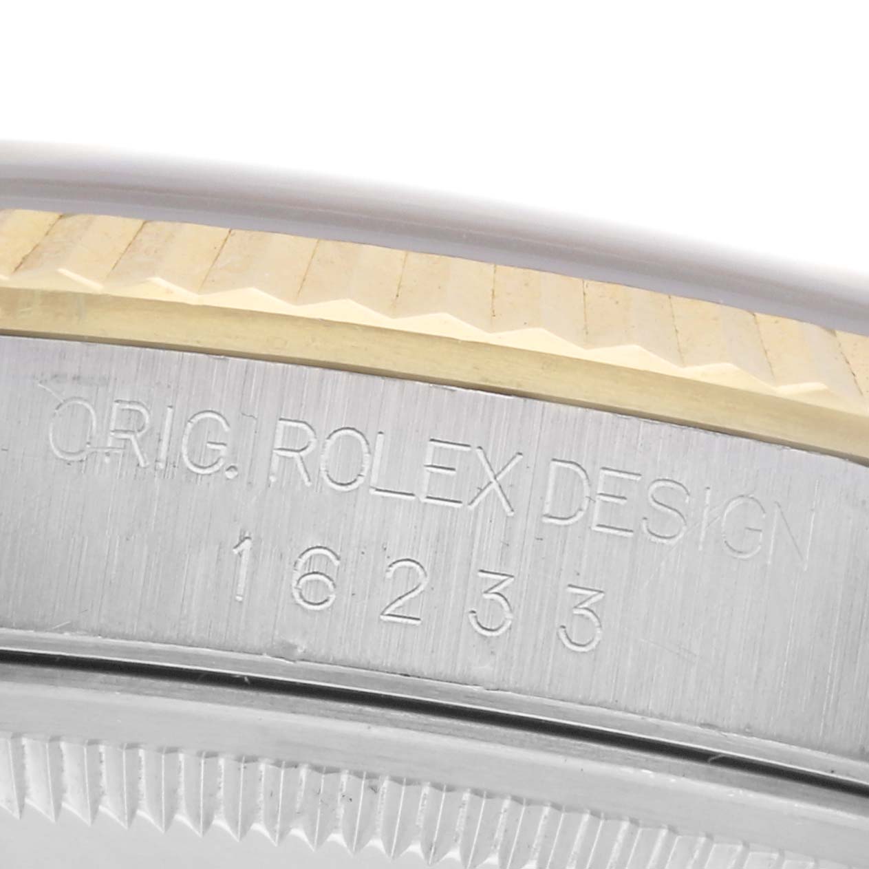 The image shows a close-up side view of the Rolex Datejust 16233 Men
s Steel and Gold (two tone) White Dial 16233 Men
s Steel and Gold (two tone) White Dial, focusing on the engraved bezel with text detailing design and model number.