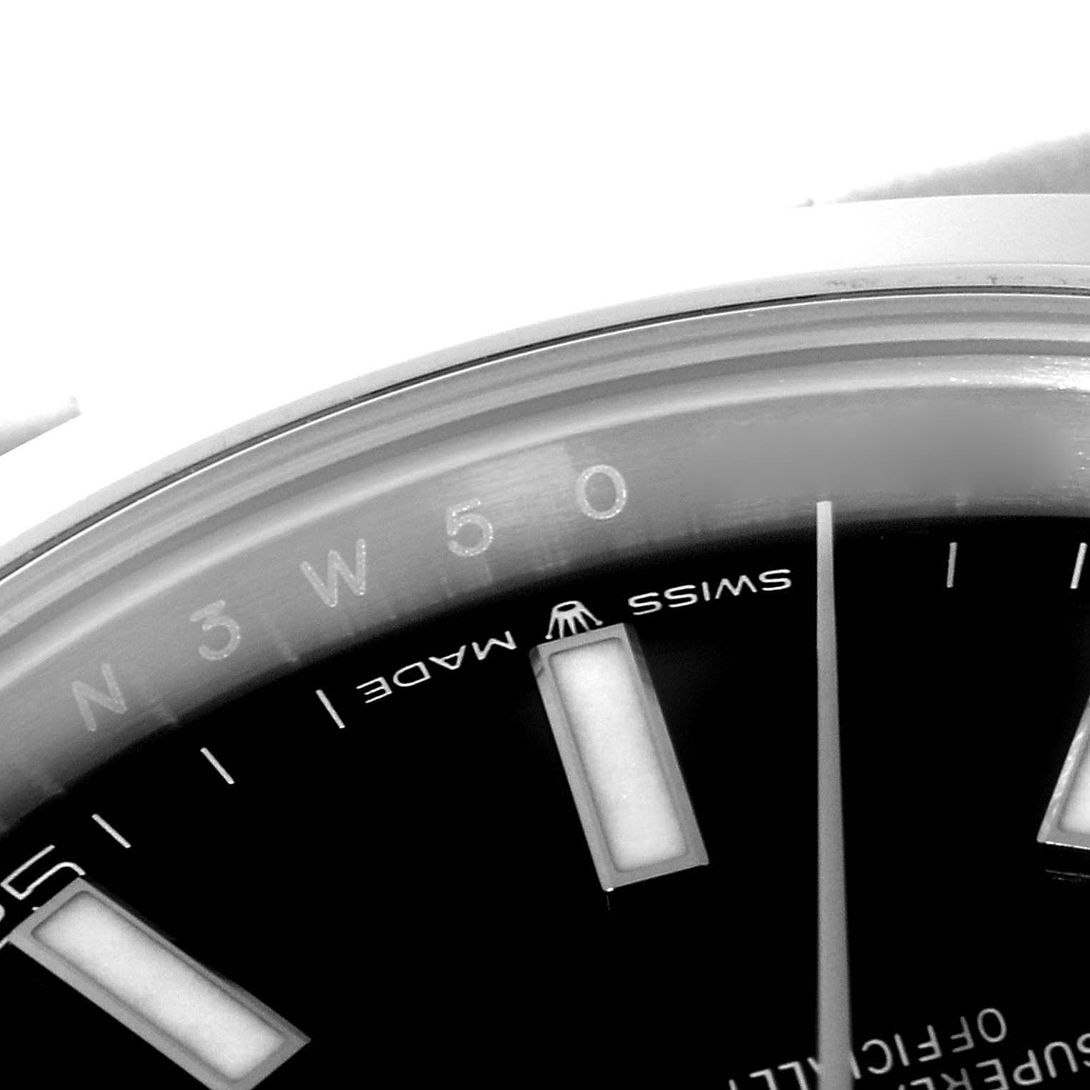 This close-up image of a Rolex Datejust 41 126300 Men's Stainless Steel Black Dial 126300 Men's Stainless Steel Black Dial shows the dial with part of the "Swiss Made" inscription and hour markers.