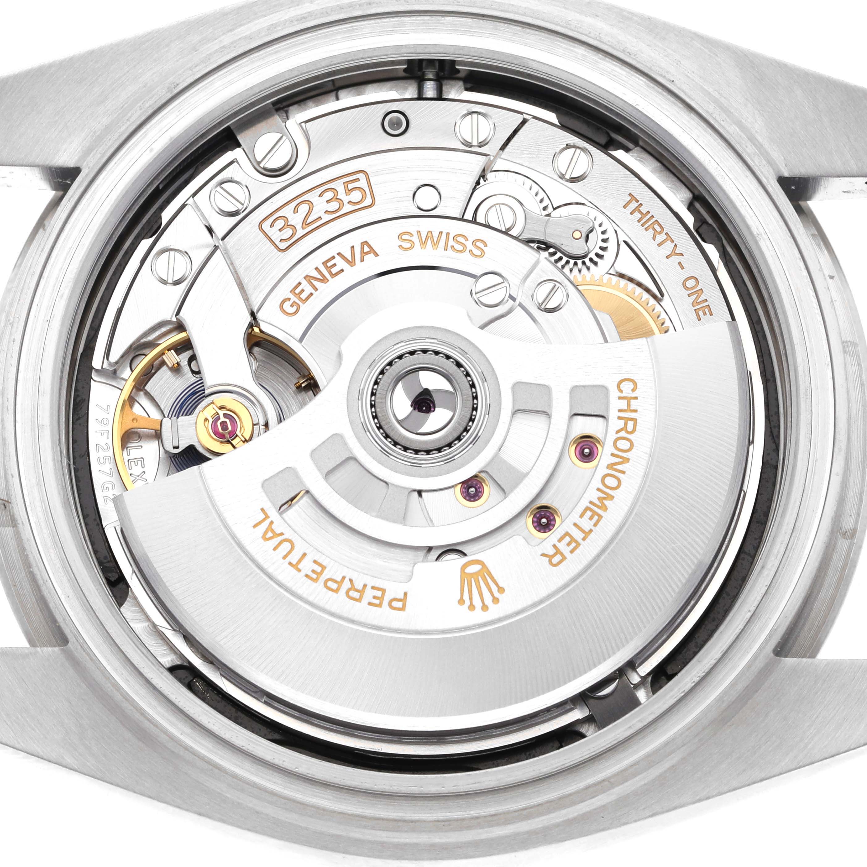 This is an image of the Rolex Datejust 41 126300 Men's Stainless Steel Black Dial 126300 Men's Stainless Steel Black Dial watch taken from the back, showcasing its movement and internal mechanisms, including the rotor and engravings.