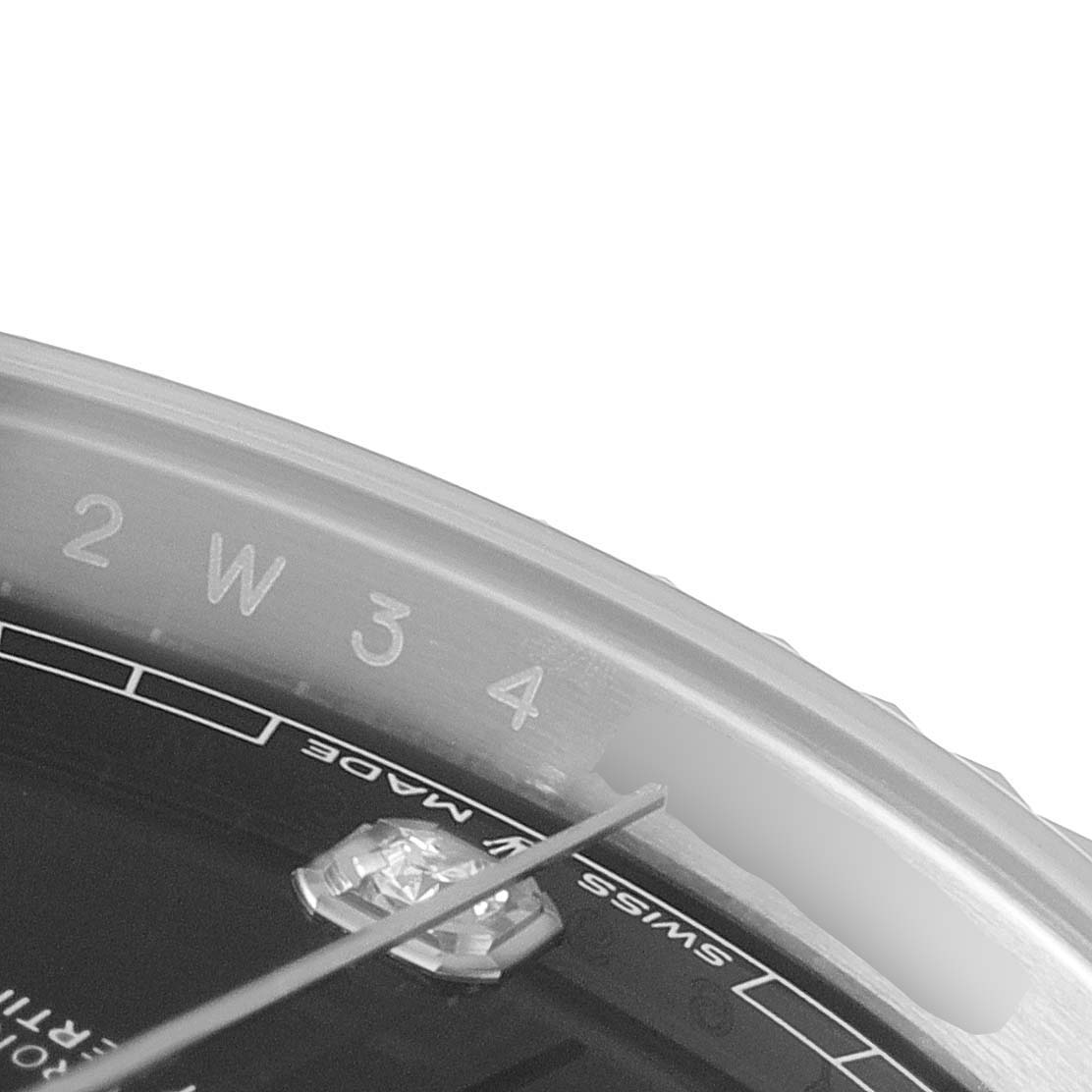 The image shows a close-up of the outer dial and edge of a Rolex Datejust 41 126334 Men
s Stainless Steel Black Dial 126334 Men
s Stainless Steel Black Dial watch, displaying part of the hour markers and the "Swiss Made" text.