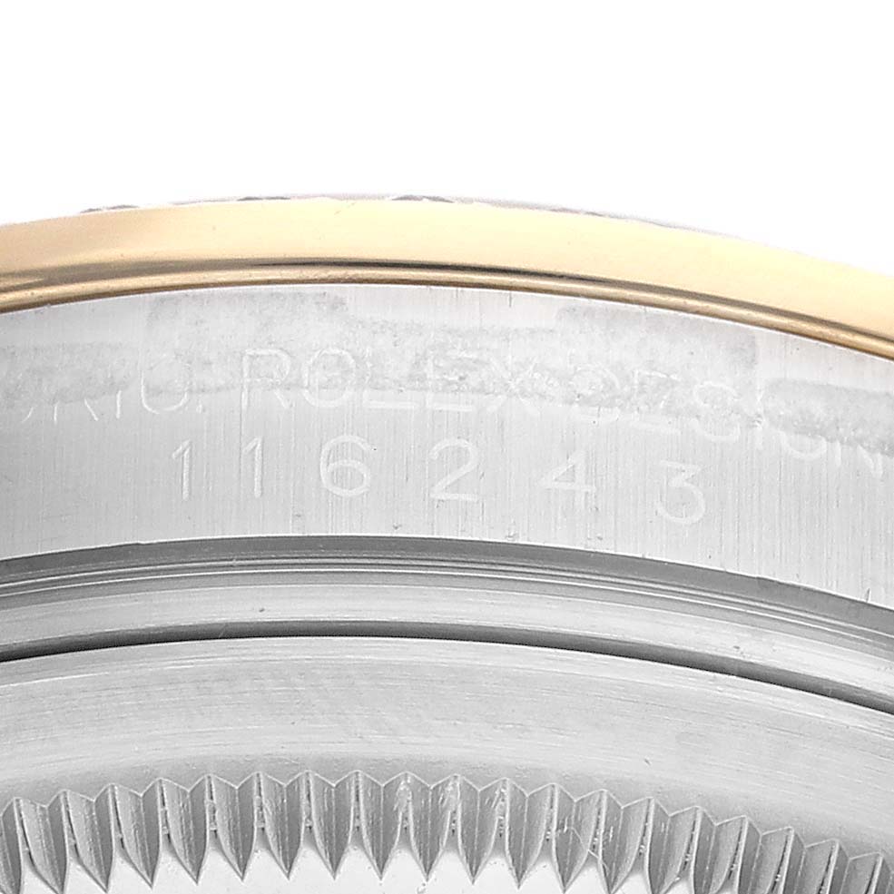 This close-up image shows the model engraving and part of the fluted bezel of a Rolex Datejust 116243 Men's Steel and Gold (two tone) Champagne Dial 116243 Men's Steel and Gold (two tone) Champagne Dial watch.