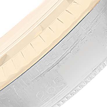 This close-up image shows the side of the bezel and part of the stainless steel casing of the Vintage Collection model by Rolex.
