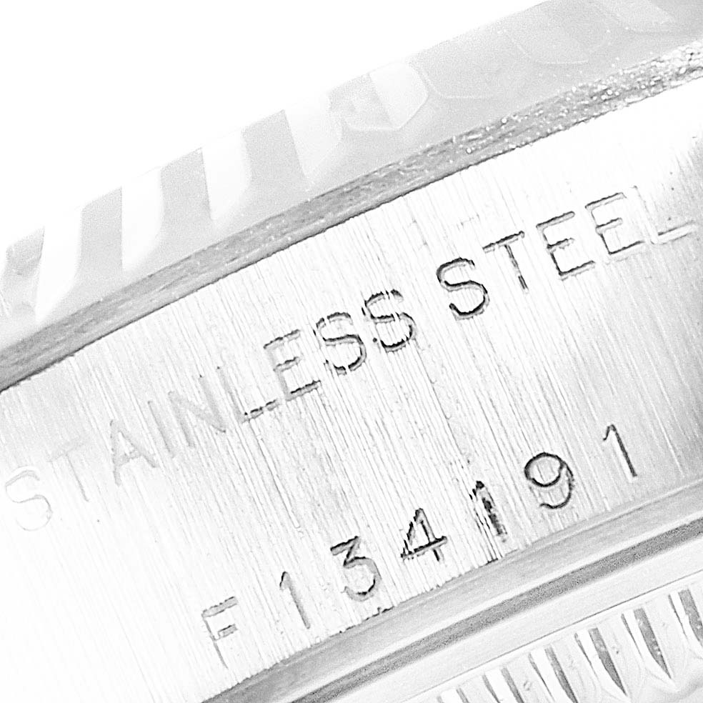 This close-up image of a Rolex Datejust 79174 Women
s Stainless Steel Mother of Pearl Dial 79174 Women
s Stainless Steel Mother of Pearl Dial watch shows the "STAINLESS STEEL" engraving on the case.
