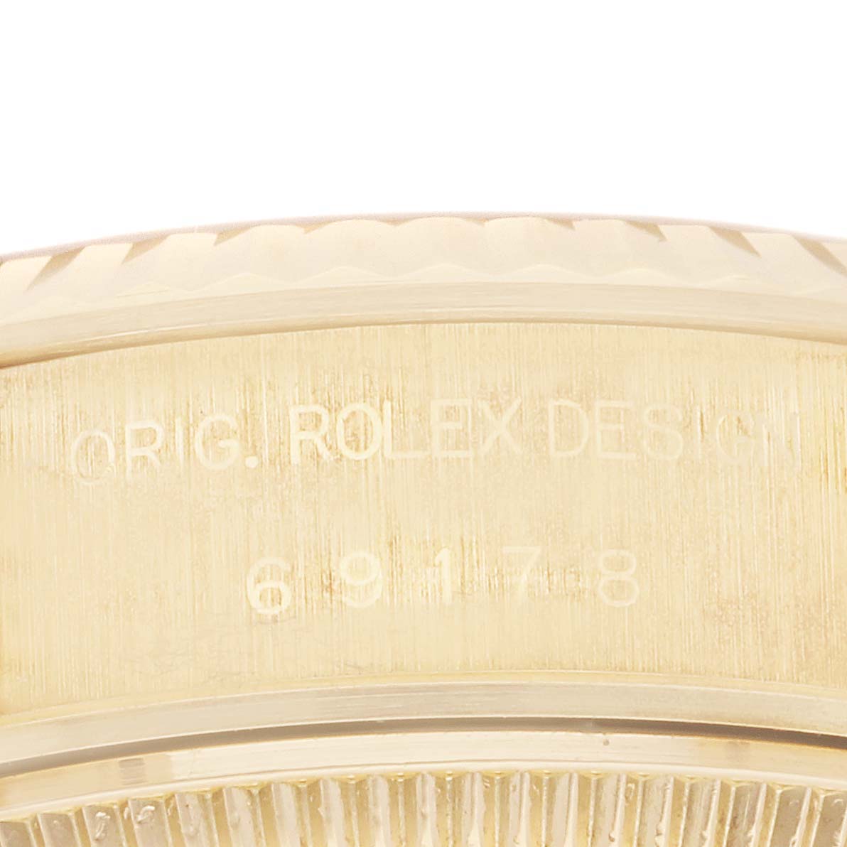 This close-up image shows the side of the case of a Rolex President 69178 Women's Yellow Gold Champagne Dial 69178 Women's Yellow Gold Champagne Dial model watch, highlighting the engraved model number.