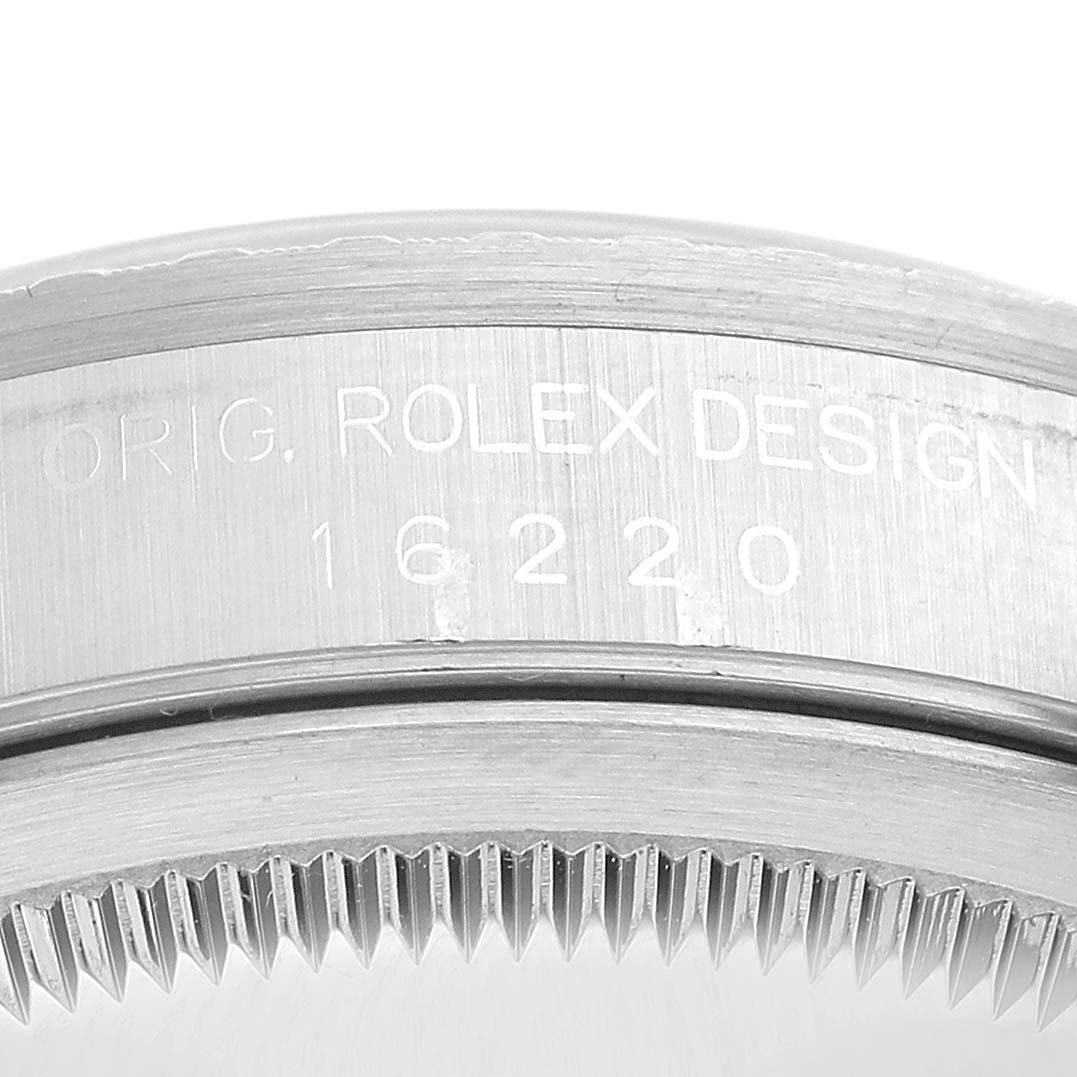 This close-up image shows the engraved side of the bezel on a Rolex Datejust 16220 Men's Stainless Steel Silver Dial 16220 Men's Stainless Steel Silver Dial watch.