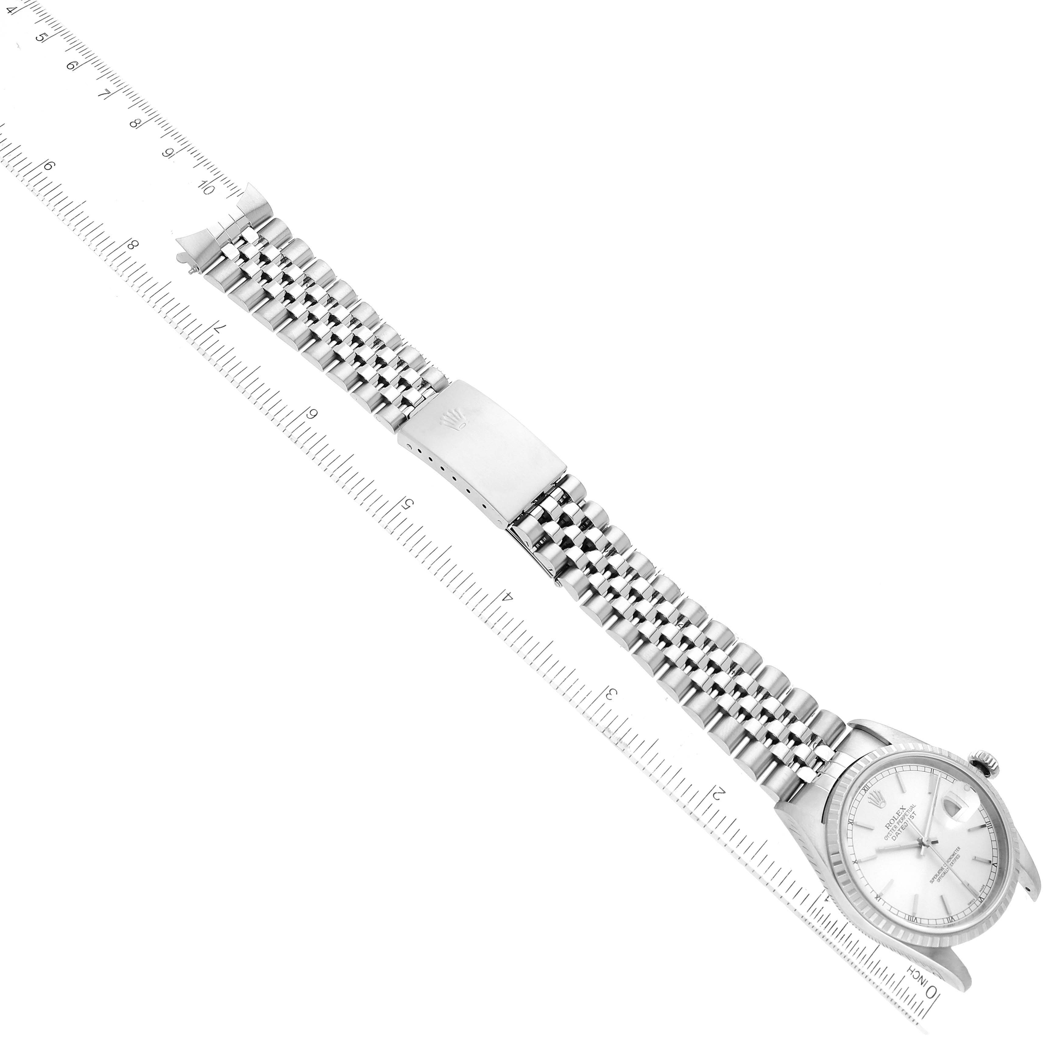 The image shows a Rolex Datejust 16220 Men's Stainless Steel Silver Dial 16220 Men's Stainless Steel Silver Dial watch laid flat with the face and bracelet fully visible, alongside measuring rulers.