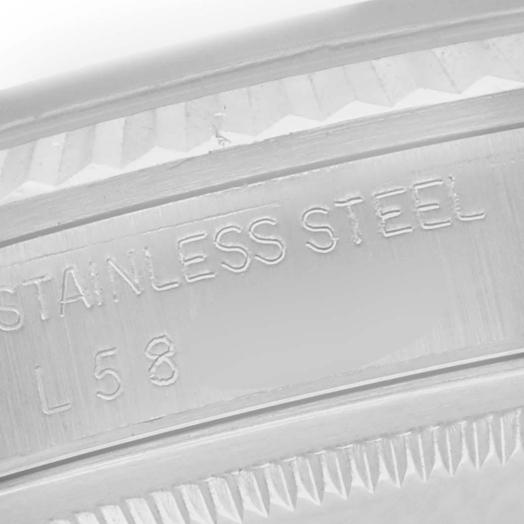 The image shows a close-up of the engraved side of a Rolex Datejust 16220 Men
s Stainless Steel Silver Dial 16220 Men
s Stainless Steel Silver Dial bezel, displaying the "STAINLESS STEEL" marking.