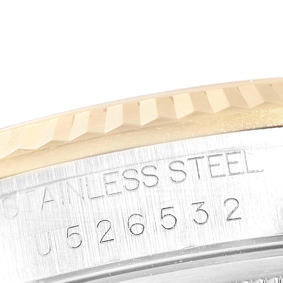 Close-up of the serial number and part of the fluted bezel on a Rolex Datejust 16233 Men's Steel and Gold (two tone) Beige Dial 16233 Men's Steel and Gold (two tone) Beige Dial watch.
